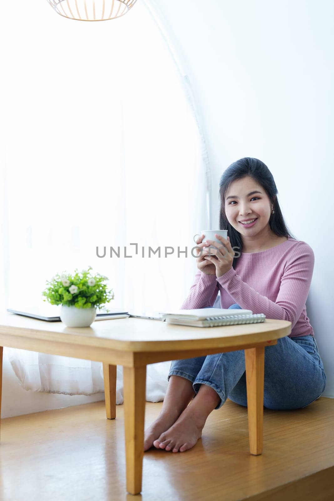 Portrait of a beautiful Asian teenage girl taking a coffee break during the day.