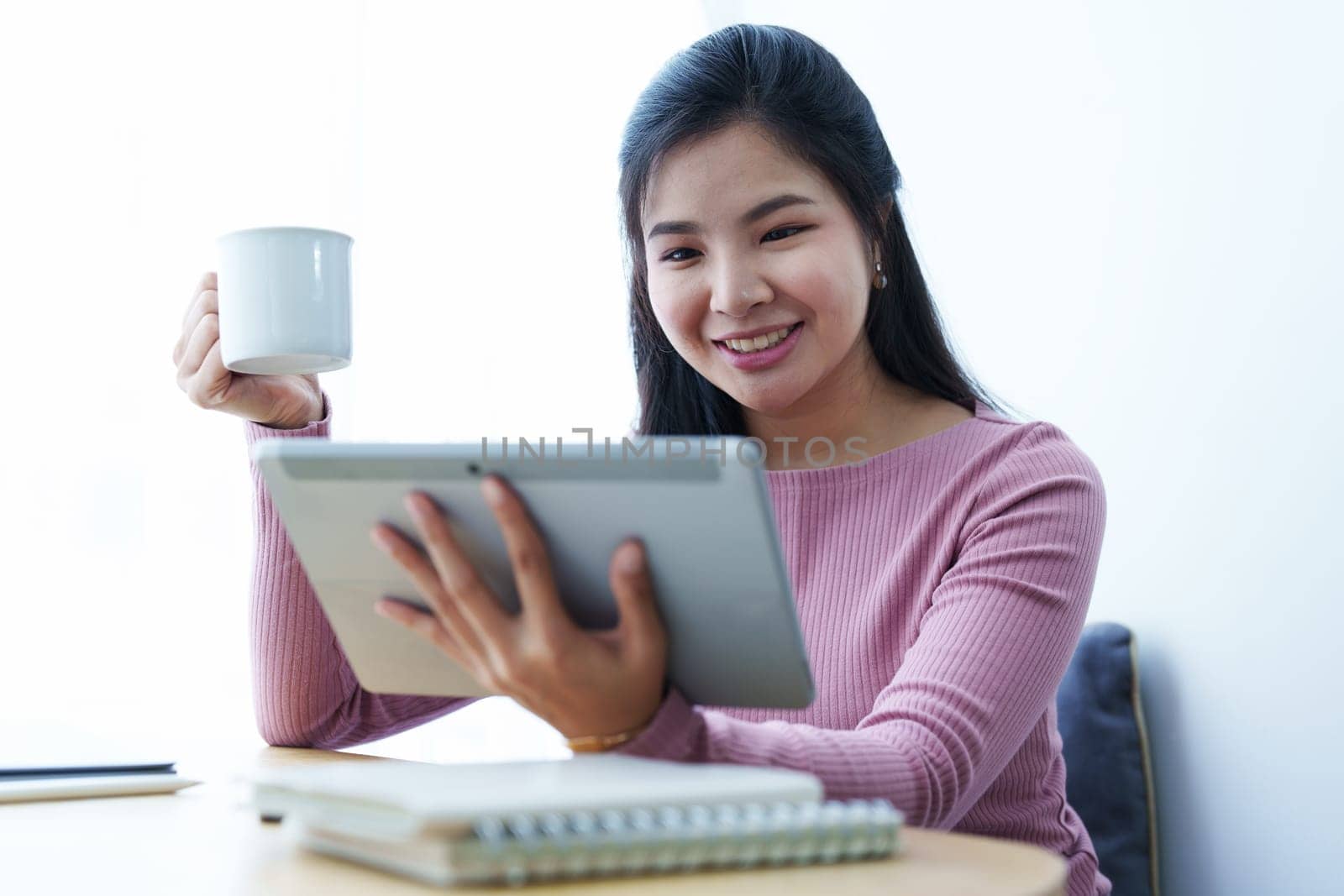 Portrait of a beautiful Asian teenage girl using a tablet computer.