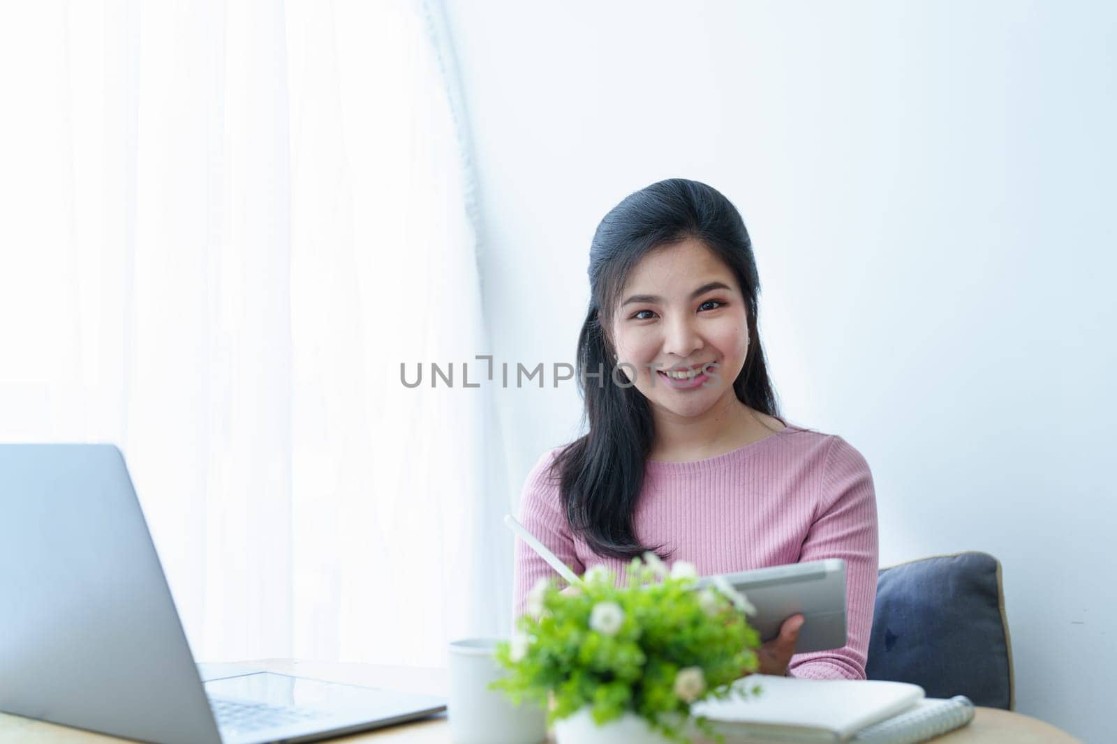 Portrait of a beautiful Asian teenage girl using a tablet computer.