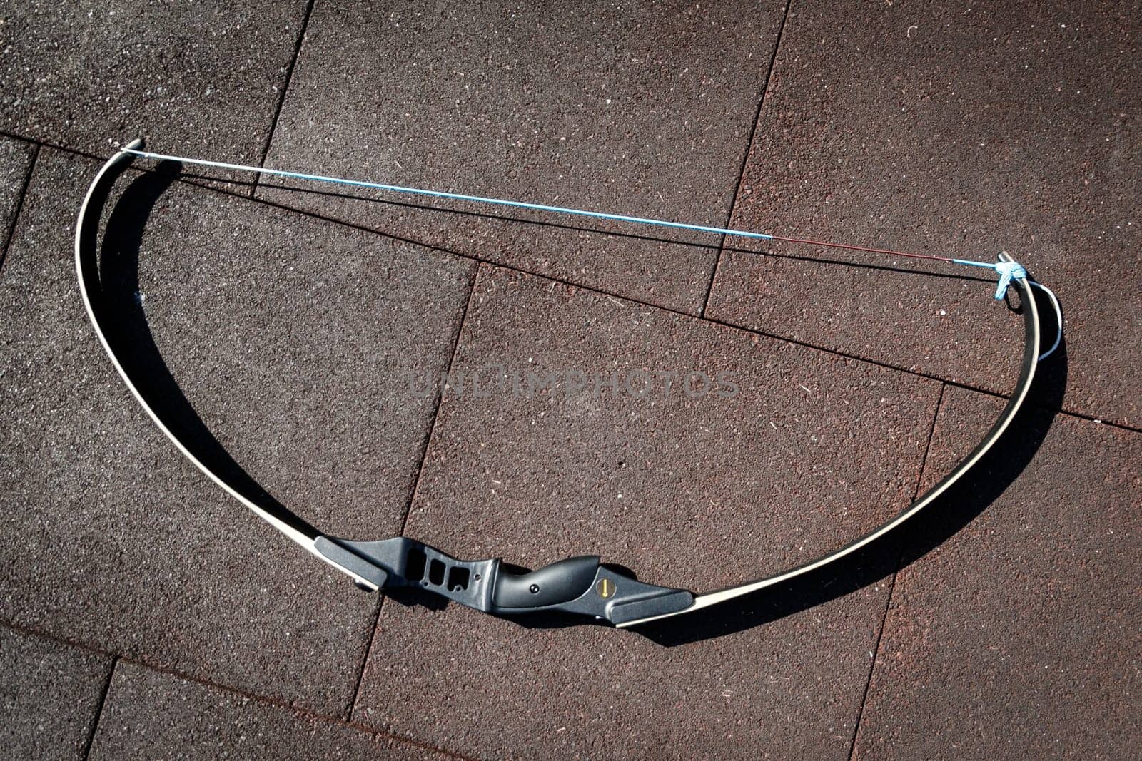 Modern sports bow lies on the sports ground at team building sports games.