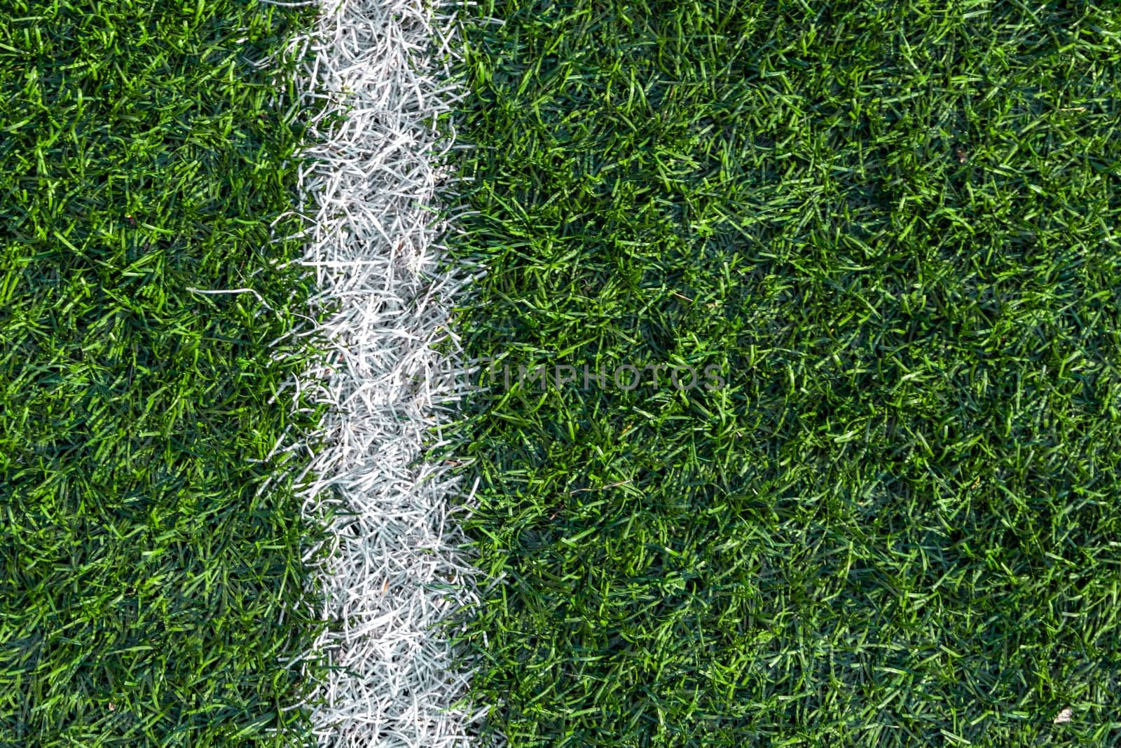 White stripe markings on the green grass of the soccer field.