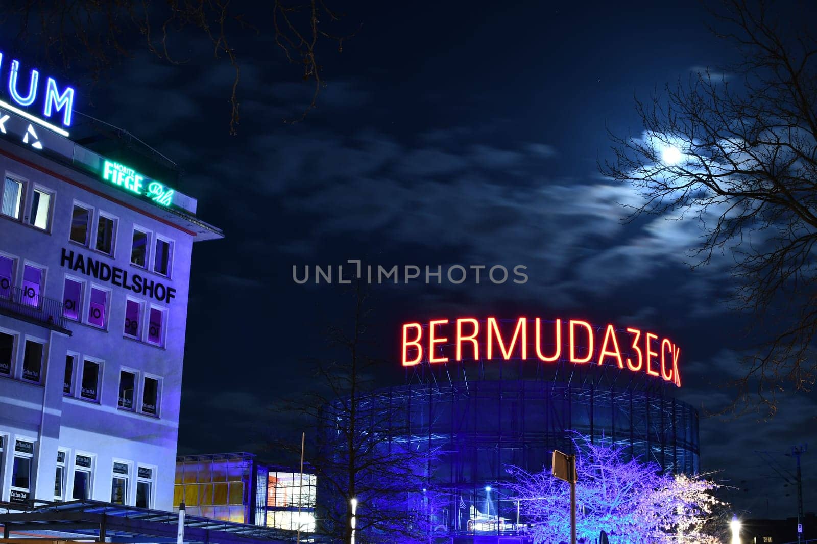 Low angle shot of an illuminated sign of the Bermuda3eck in Bochum, Germany