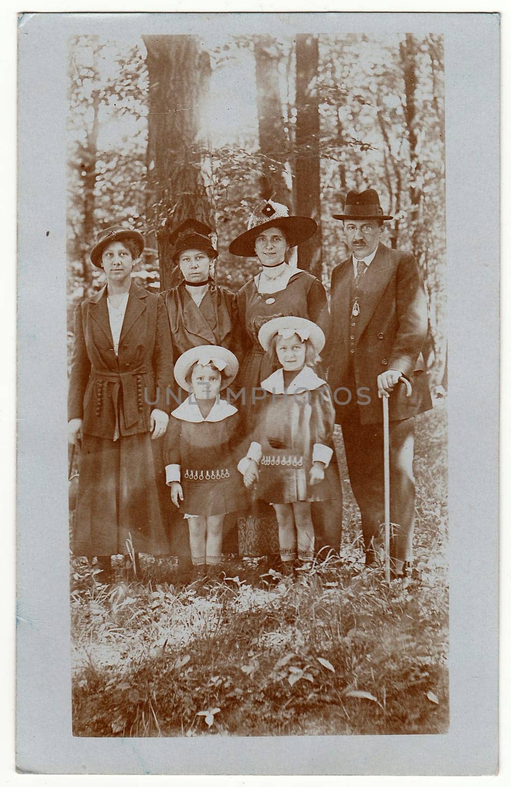 DRESDEN, GERMANY - MAY 26, 1918: Vintage photo shows family and close relatives pose in the nature in the forrest .