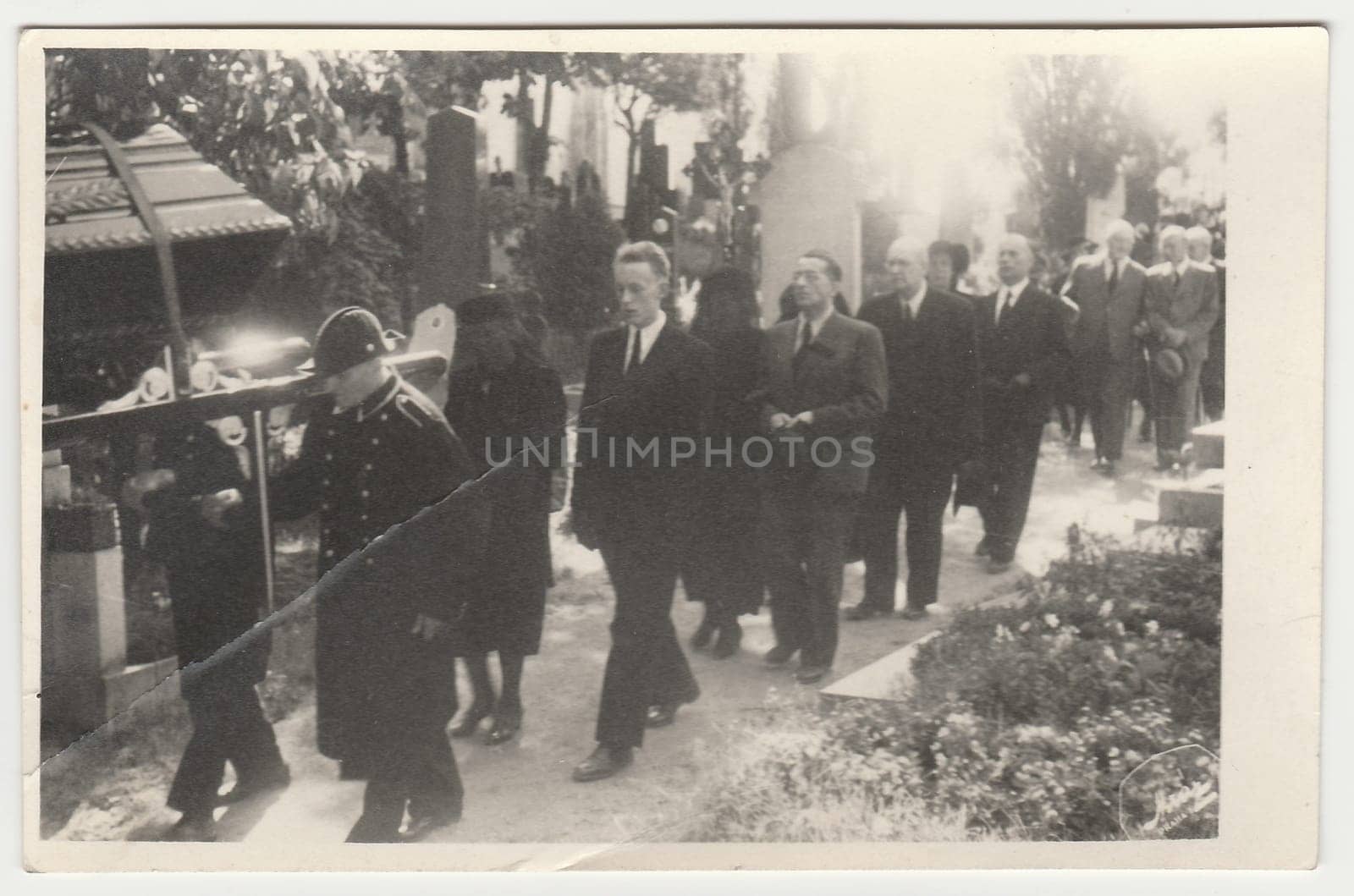 PRAHA (PRAGUE), THE CZECHOSLOVAK REPUBLIC - CIRCA 1940s: Funeral clerks carry the coffin lies on bier. Black & white antique photo.