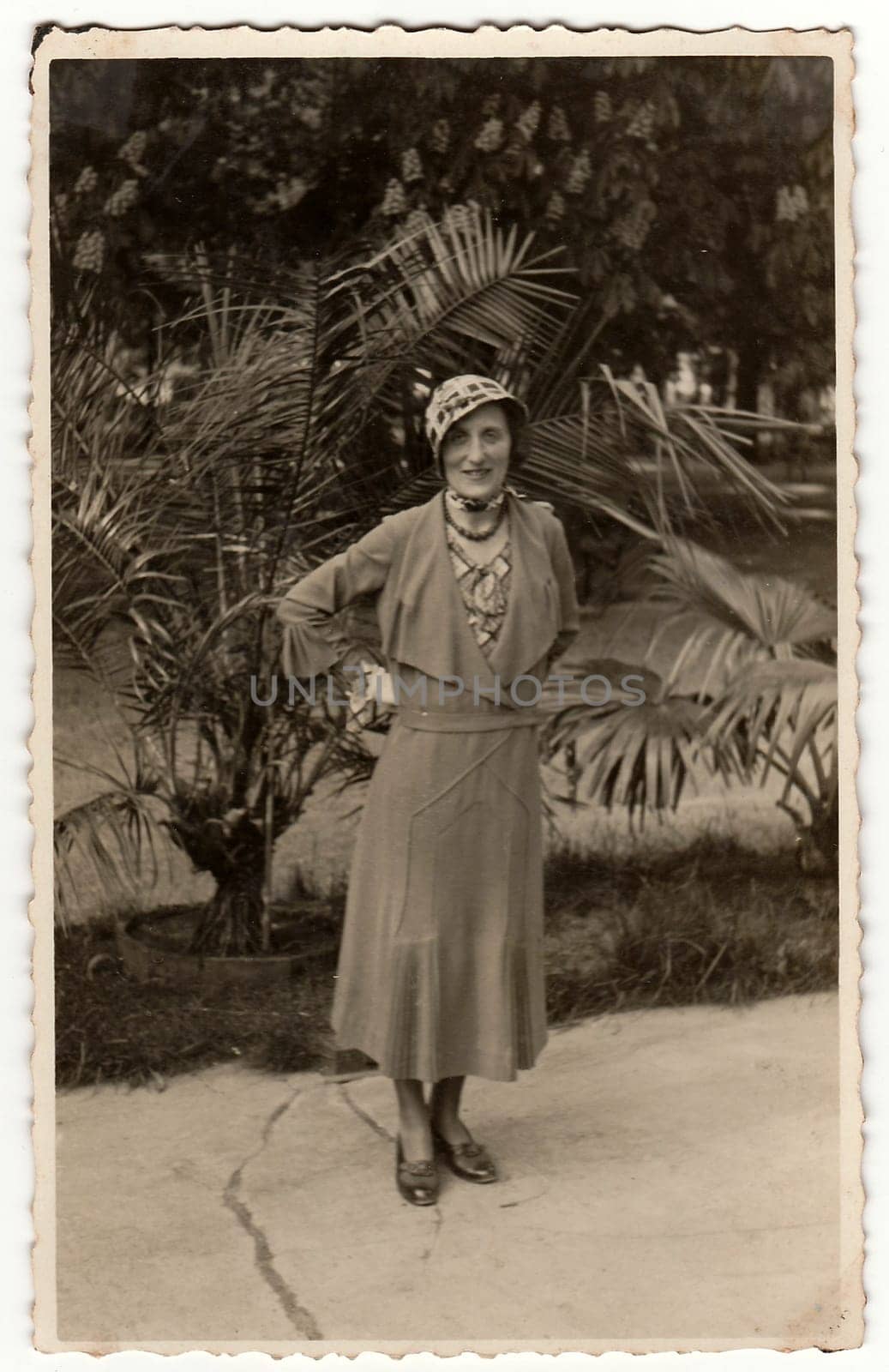 TRENCIANSKE TEPLICE, THE CZECHOSLOVAK REPUBLIC - CIRCA 1930s: Vintage photo shows an elegant woman at the spa resort. Black & white antique photography.