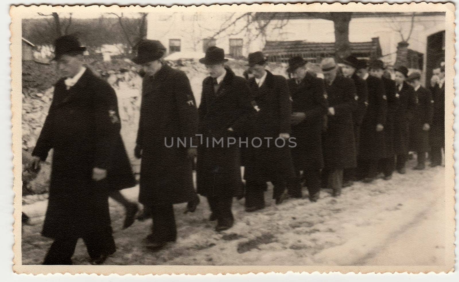 Vintage photo shows crowd of men during winter time. Black & white antique photography. by roman_nerud