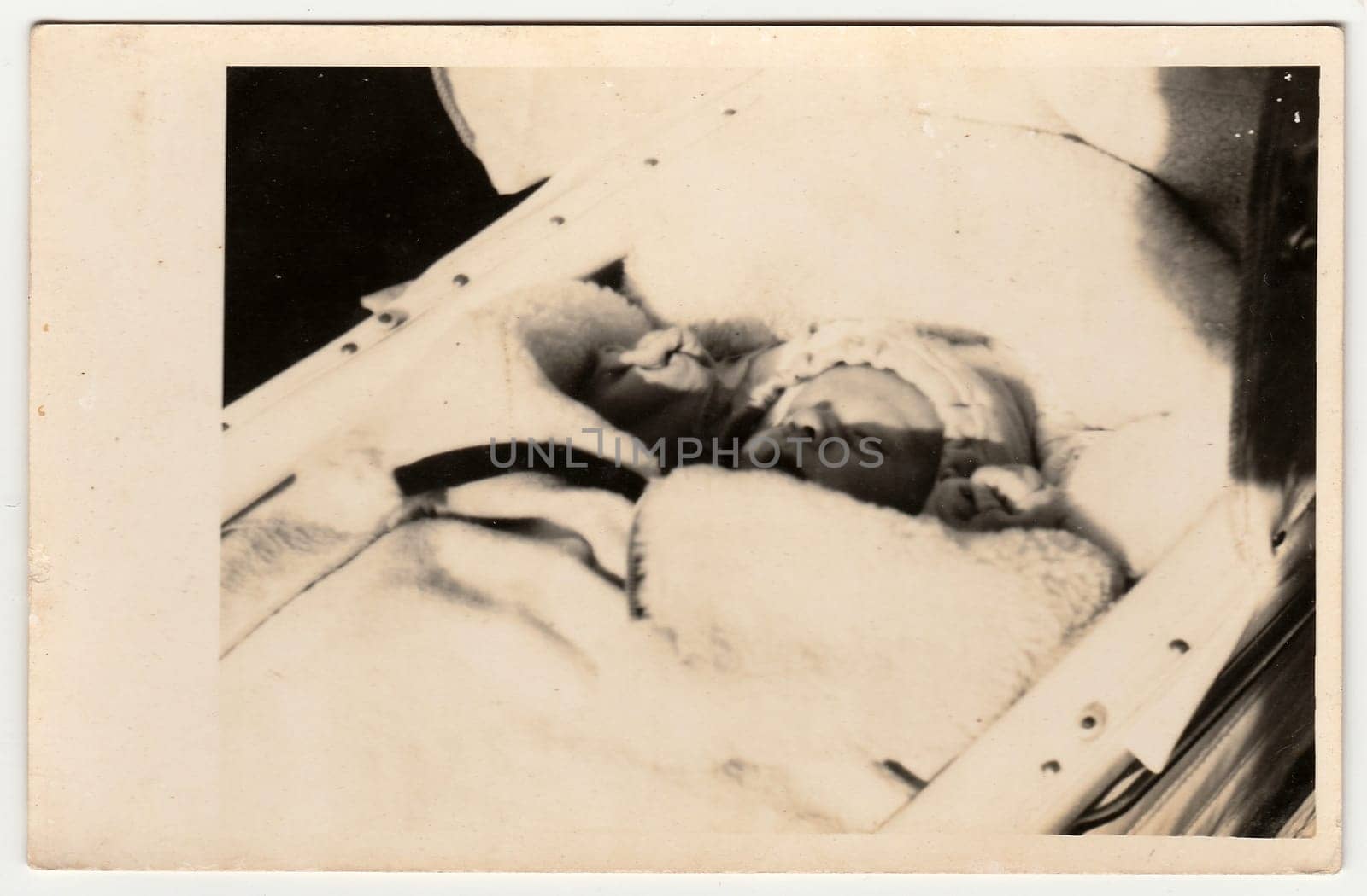 THE CZECHOSLOVAK REPUBLIC - 1927: Vintage photo shows baby sleeps in a pram (carriage). Black & white antique photography.