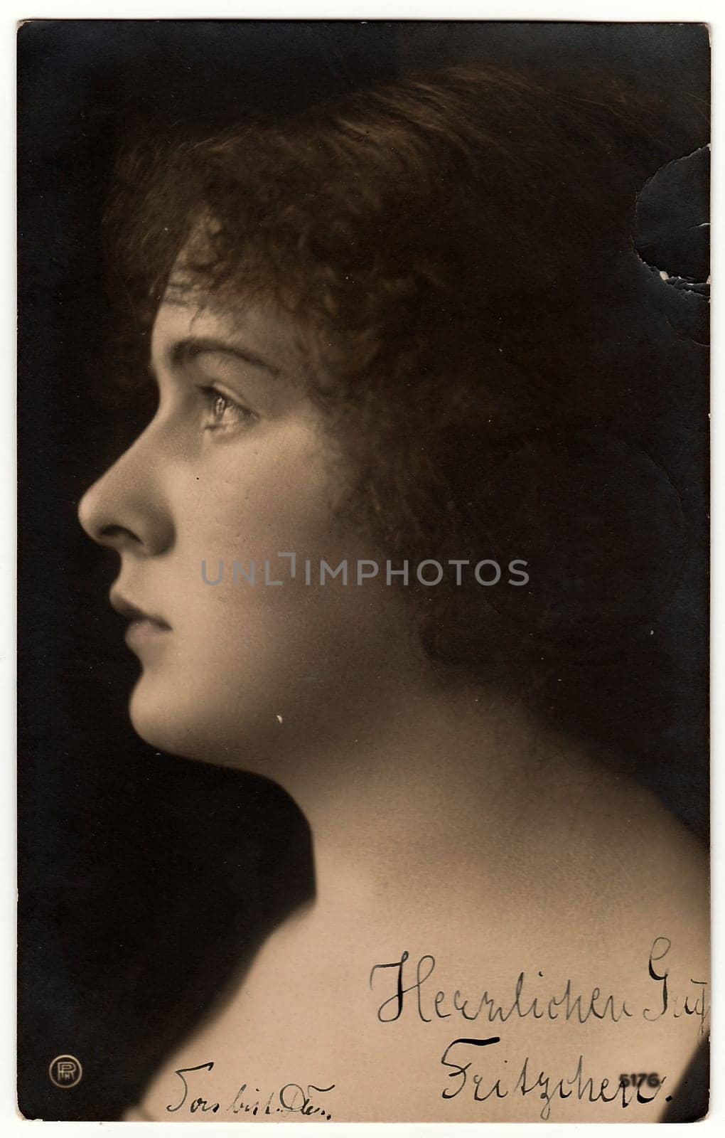 BERLIN, GERMANY - APRIL 12, 1906: The vintage photo shows portrait of young woman. The studio photography was taken in early 20th century.