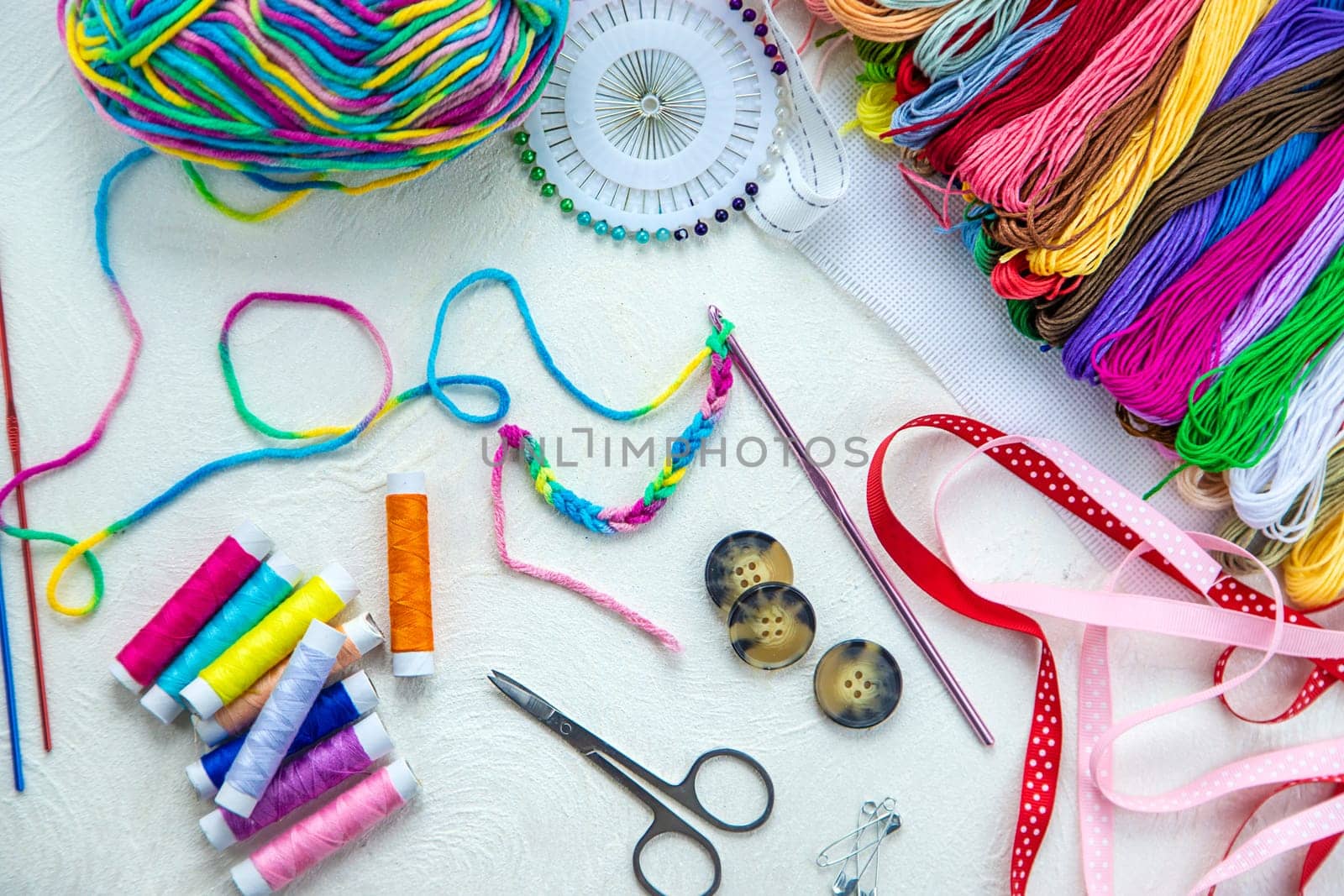 Threads and accessories for sewing and knitting. Selective focus. white.