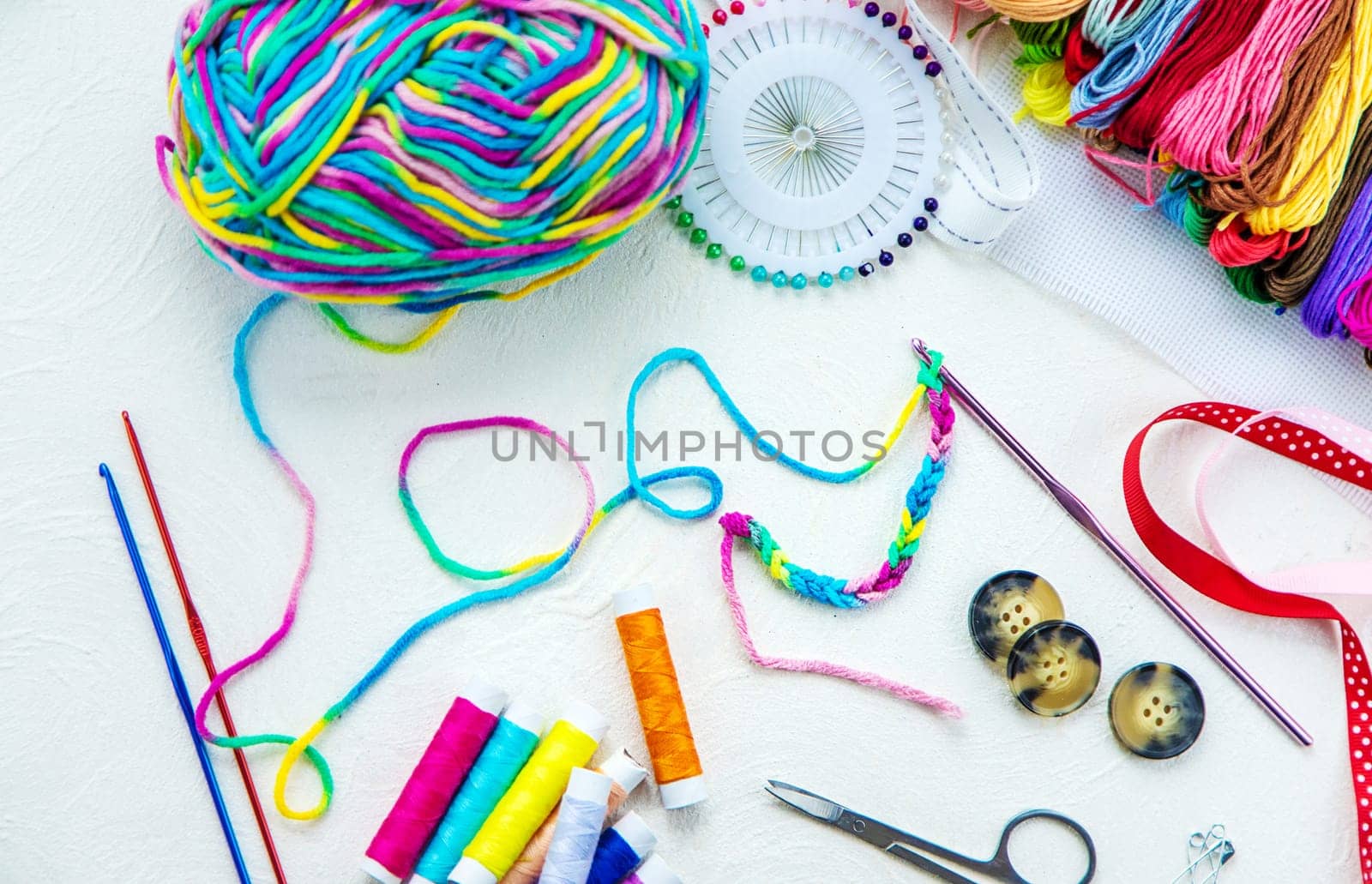 Threads and accessories for sewing and knitting. Selective focus. white.