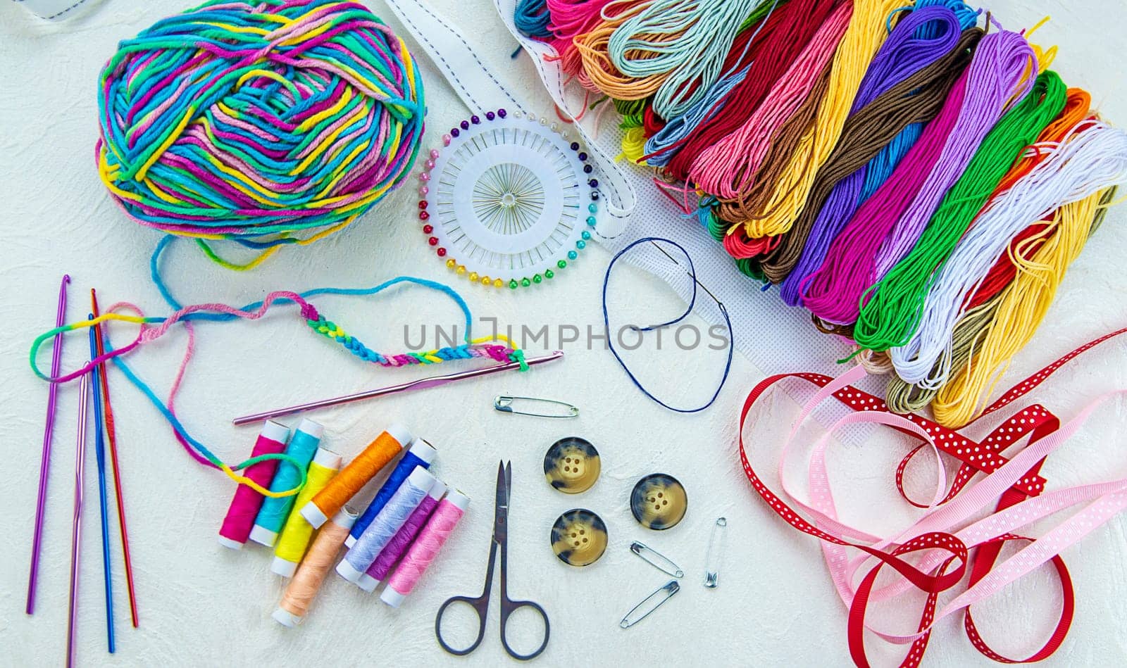 Threads and accessories for sewing and knitting. Selective focus. white.