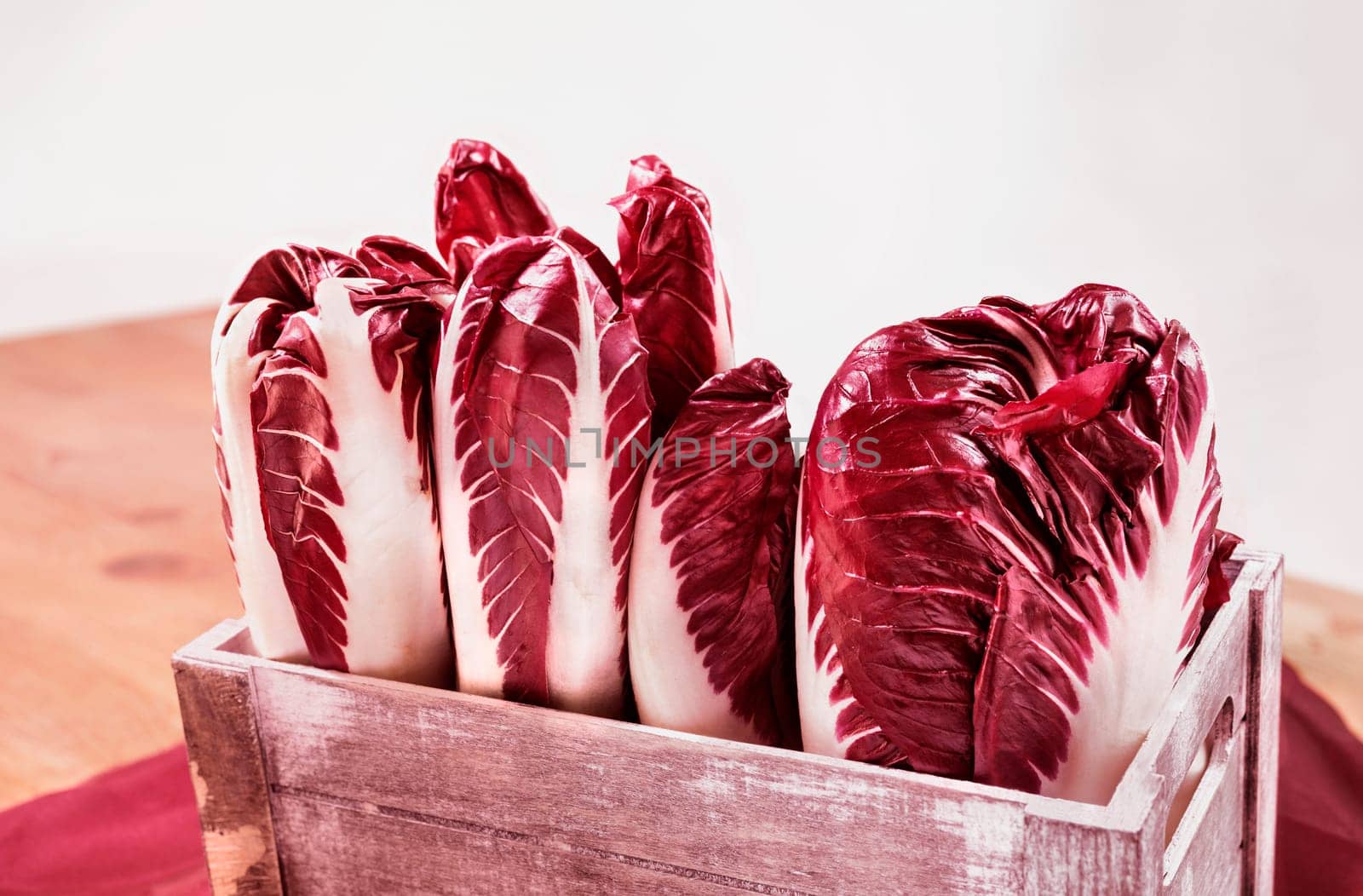 Radicchio, red  leaves chicory, italian chicory in wooden crate , common use in Italian cuisine