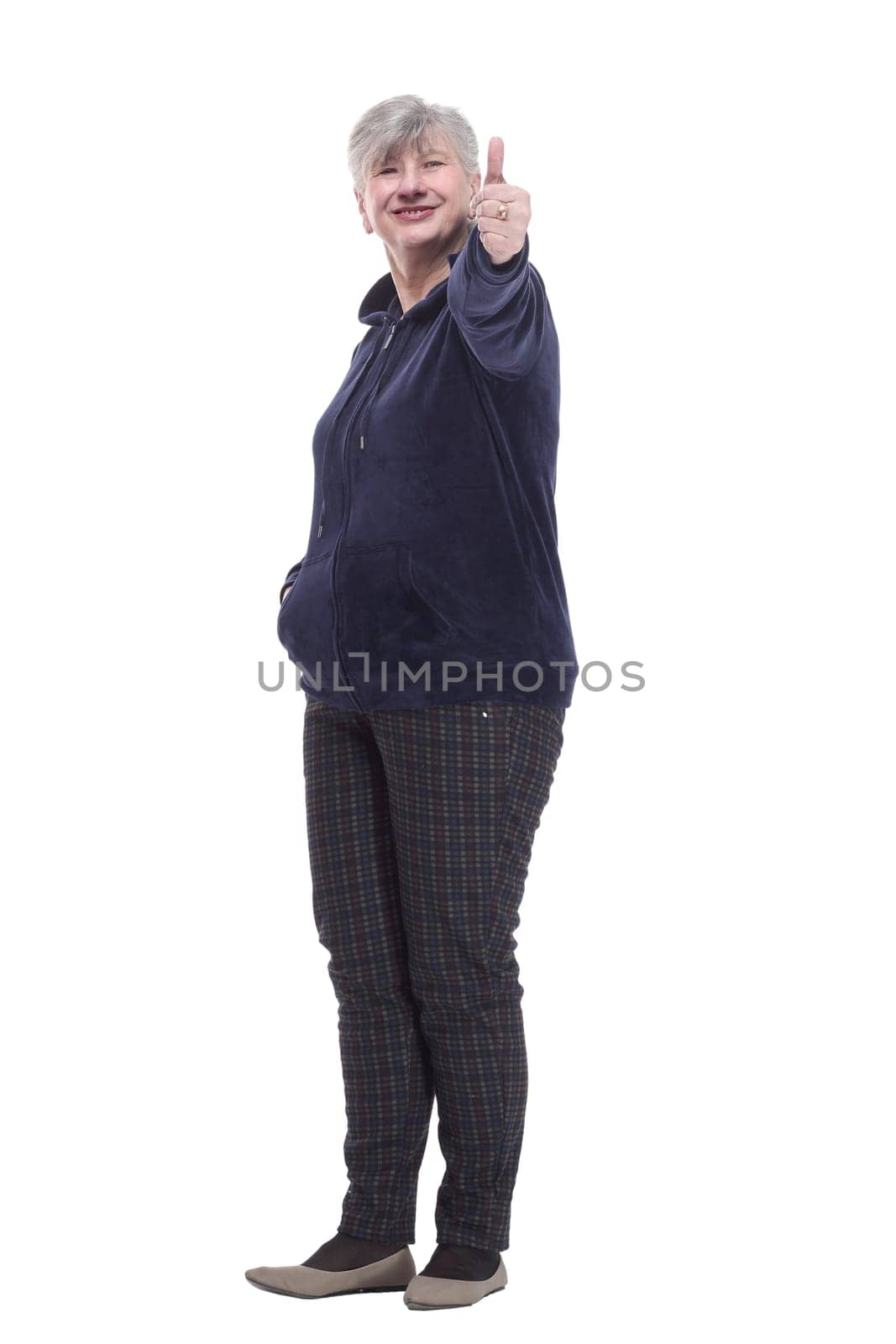 full-length. casual elderly woman in comfortable clothing showing a thumbs up . isolated on a white background.