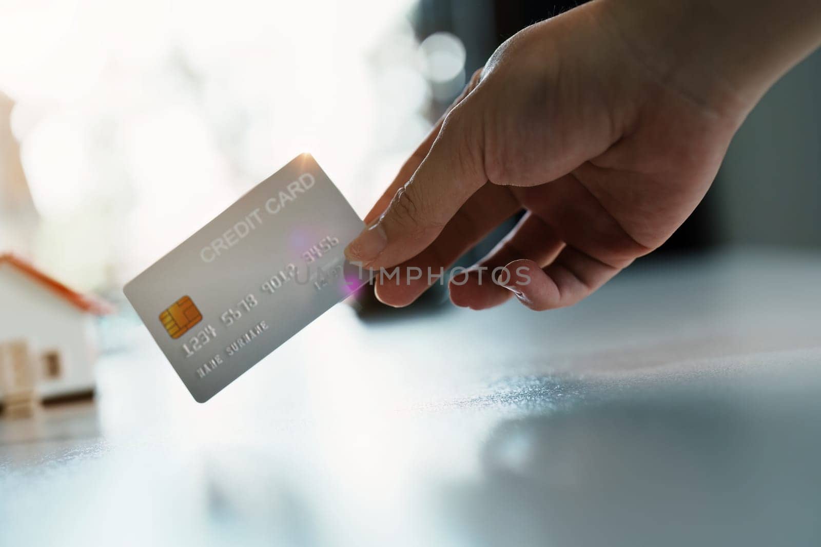 Portrait of young Asian woman holding credit card for online shopping by Manastrong