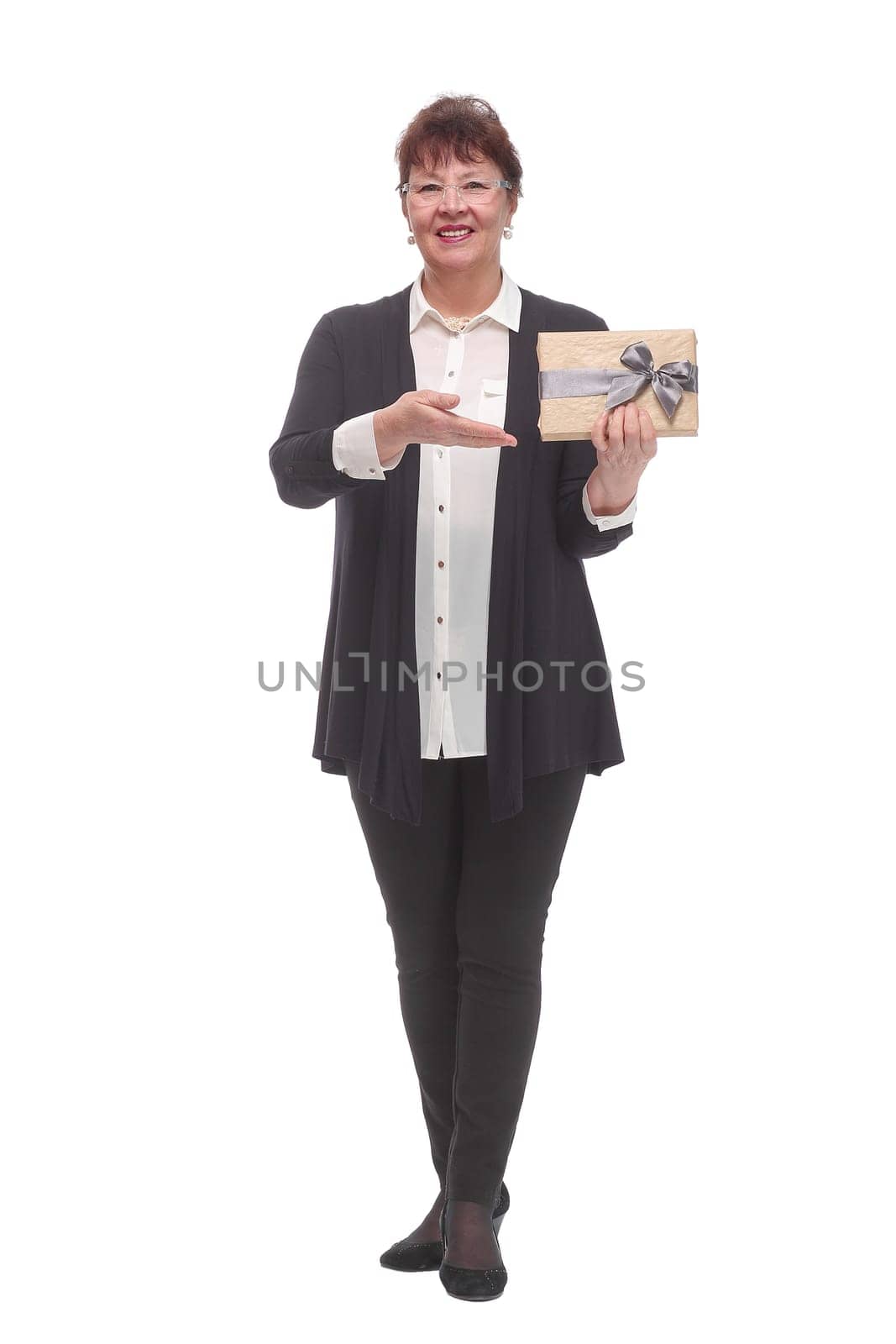 Full body senior woman happy and smiling, holding a gift looking at camera