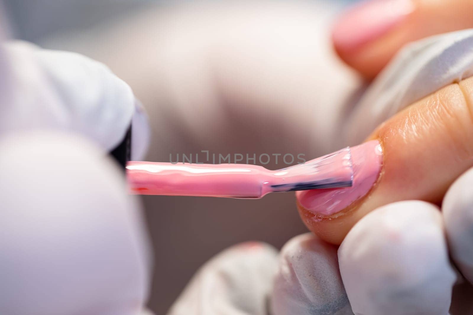 Performing the service in a beauty salon. Painting nails by a certified beautician. Maintaining the rules of hygiene in a beauty salon. Completing hybrid nail polish on the nail.