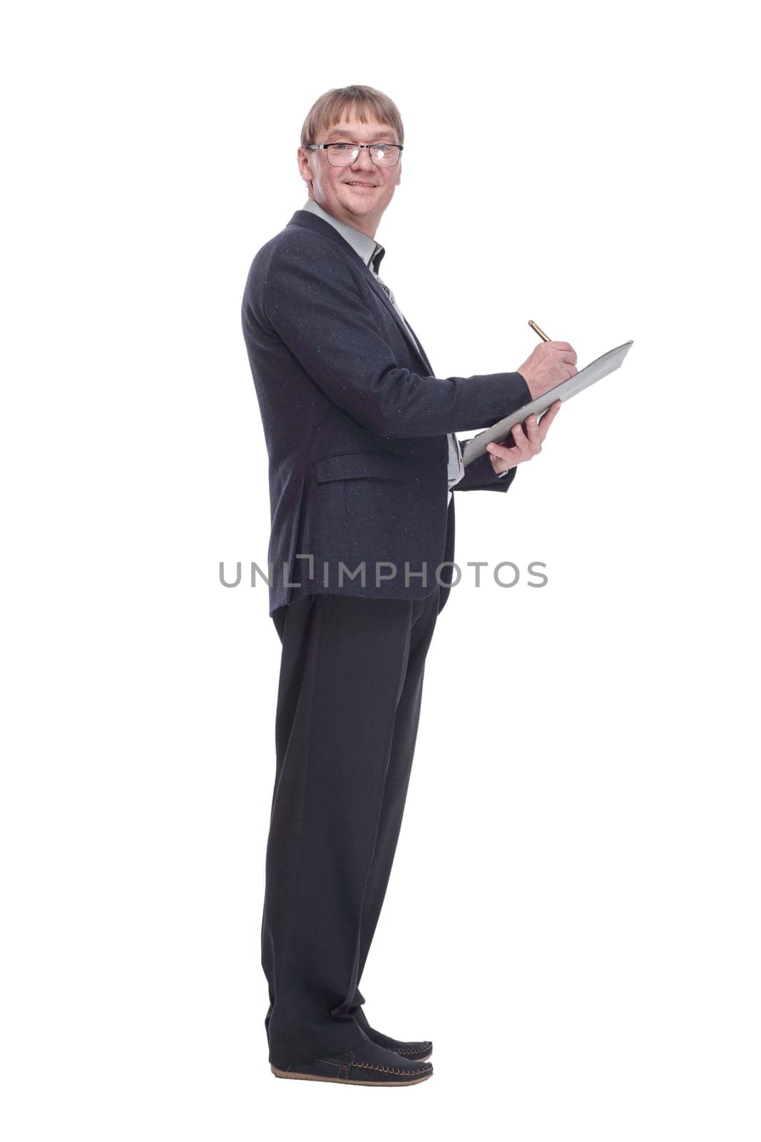 side view.senior business man making notes in the clipboard. isolated on a white background.
