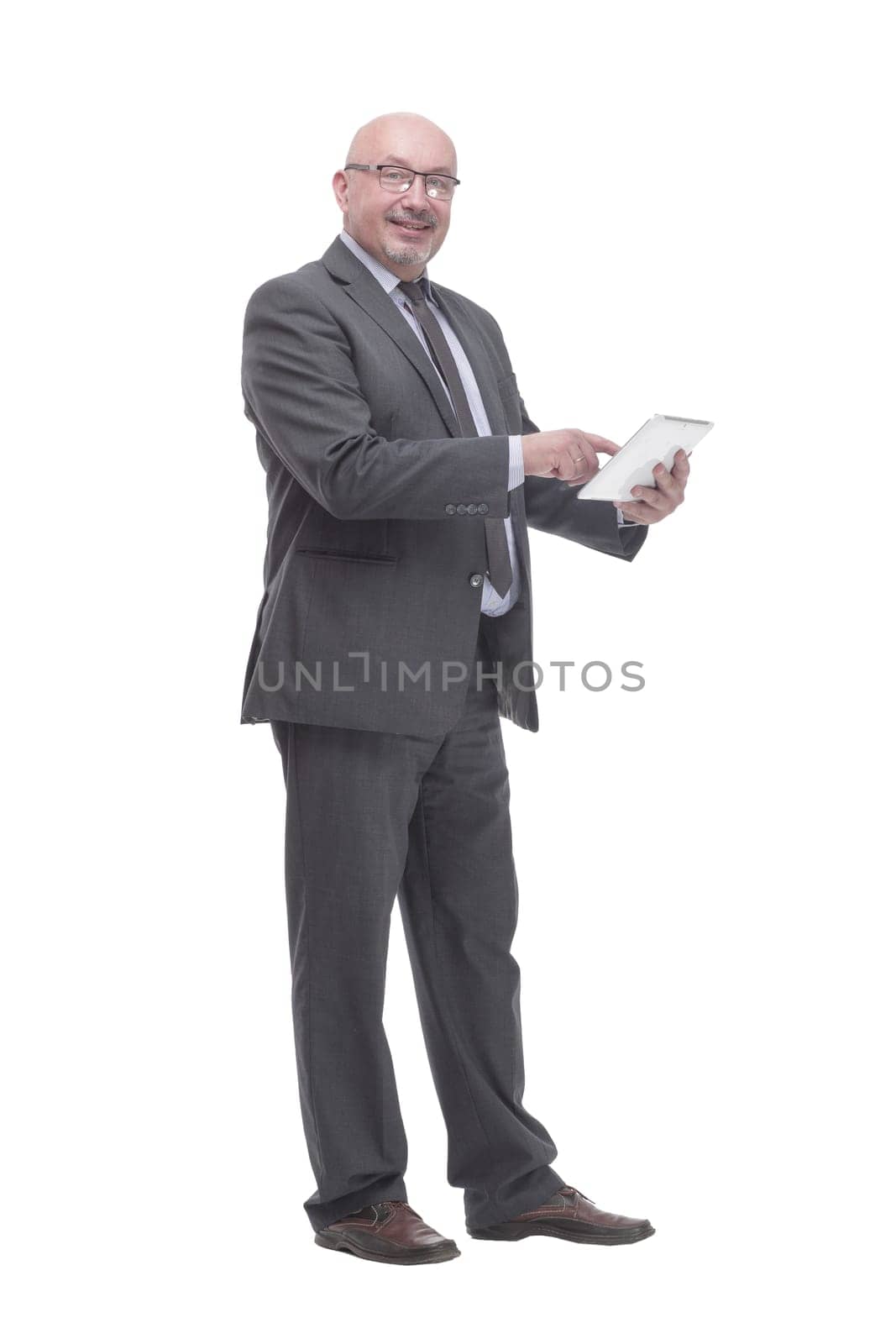in full growth. business man with a digital tablet.isolated on a white background.