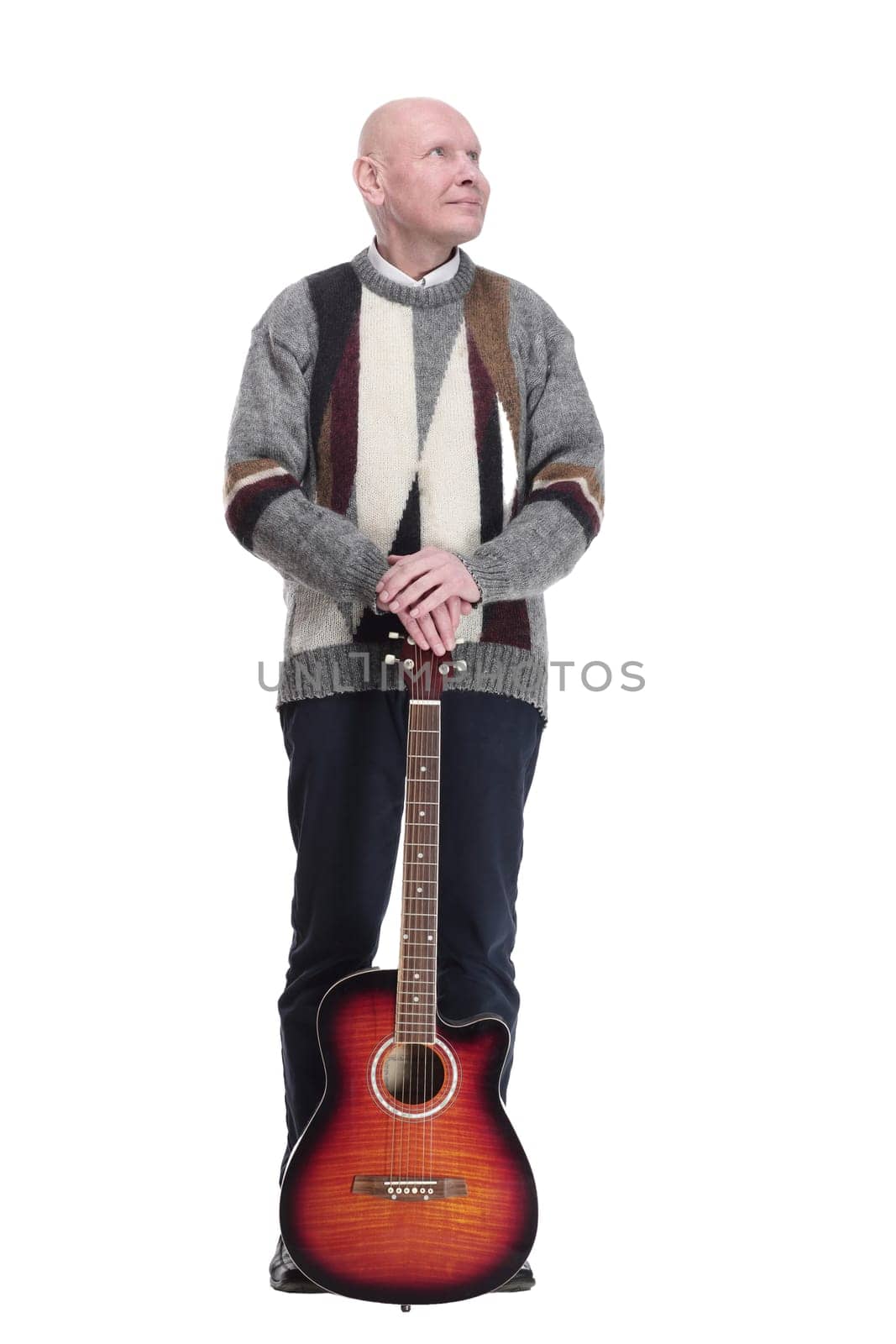full-length. mature man with guitar in hand looking at you. isolated on a white background.