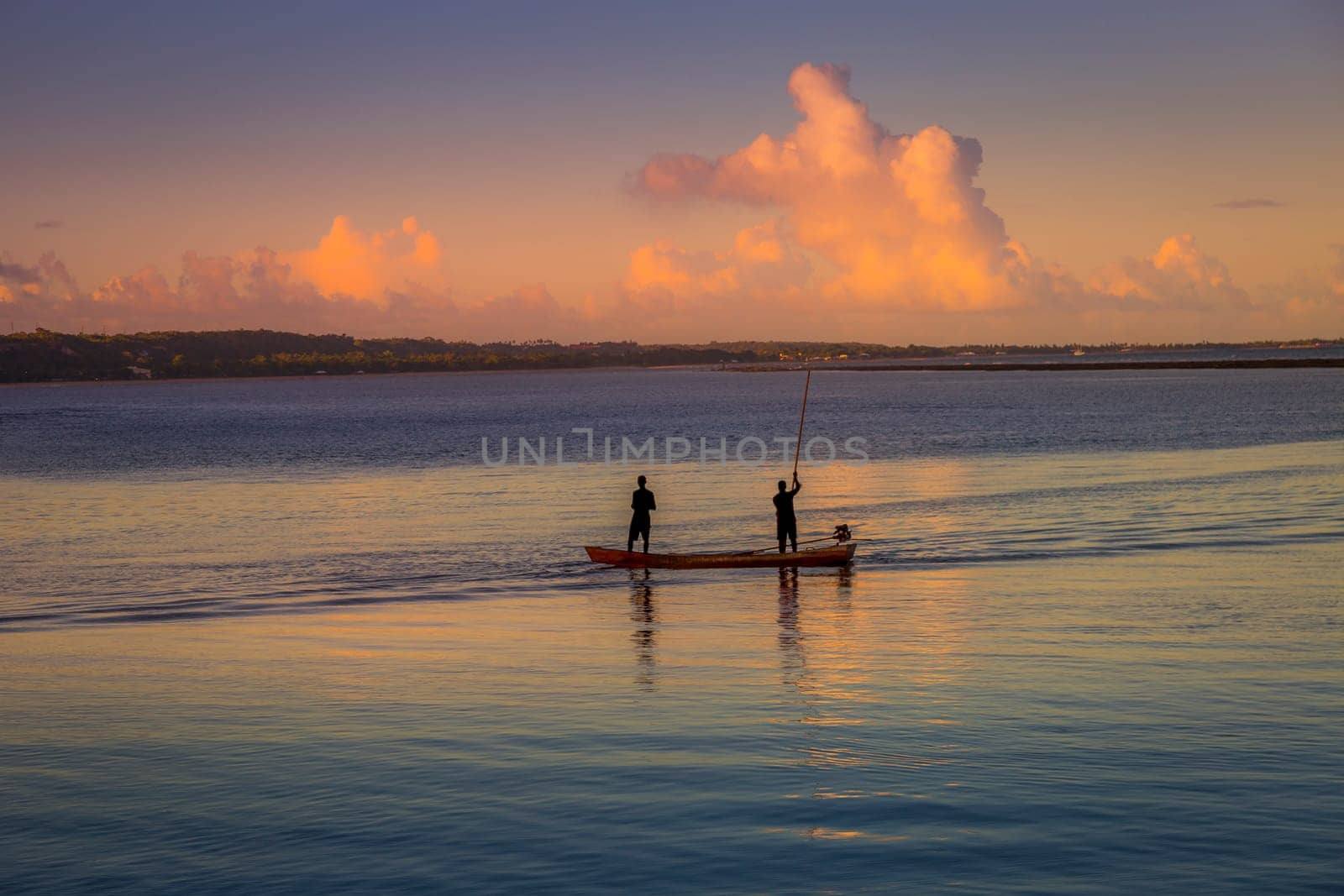 Fishermen boat in idyllic Porto Seguro at peaceful sunset , BAHIA, northeast Brazil