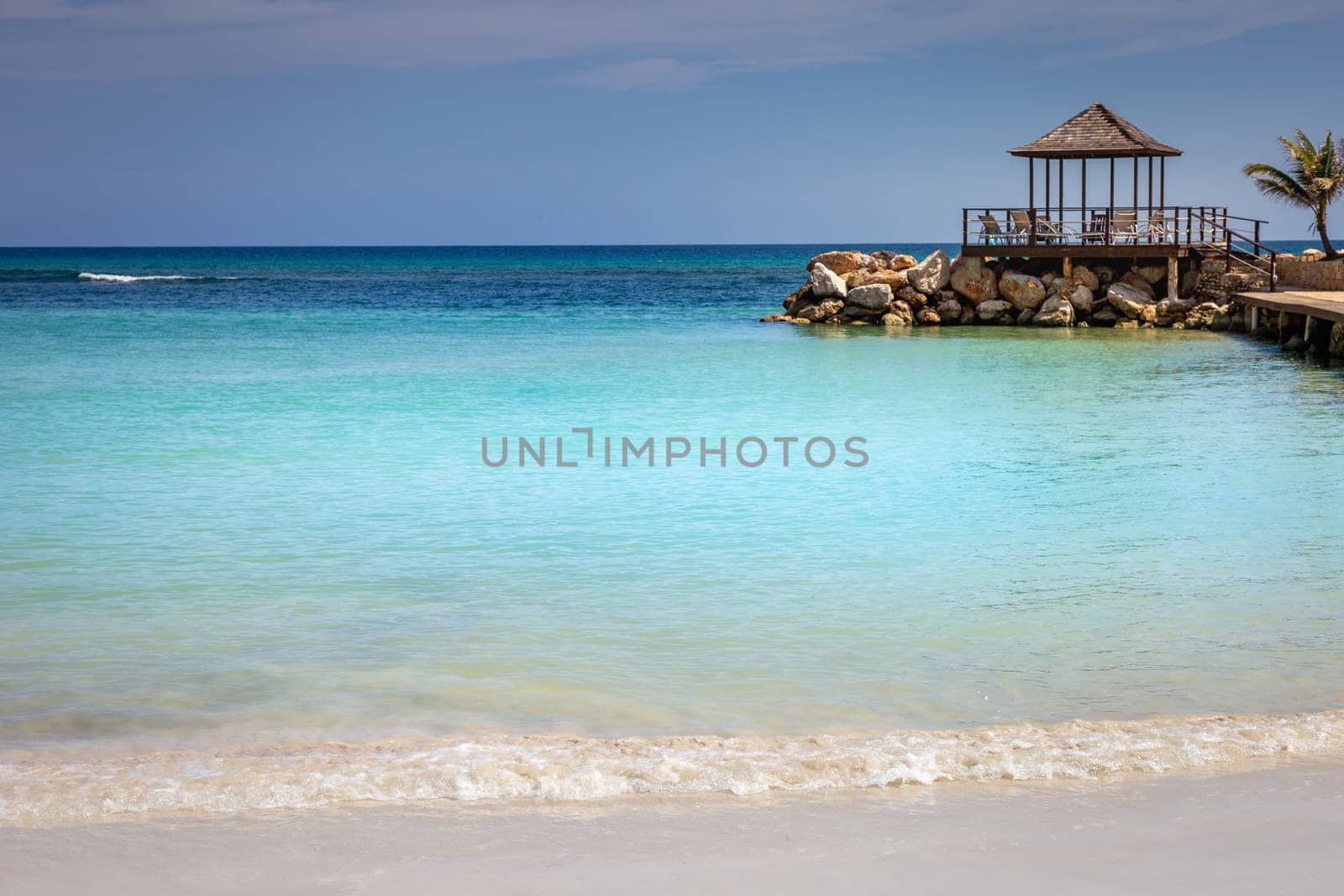 Tropical caribbean beach with turquoise waters in idyllic Montego Bay, Jamaica