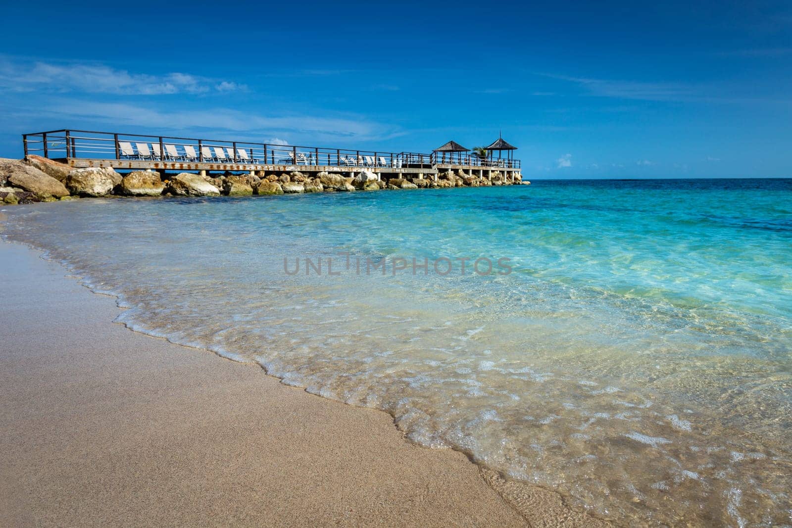 Tropical caribbean beach with turquoise waters in idyllic Montego Bay, Jamaica