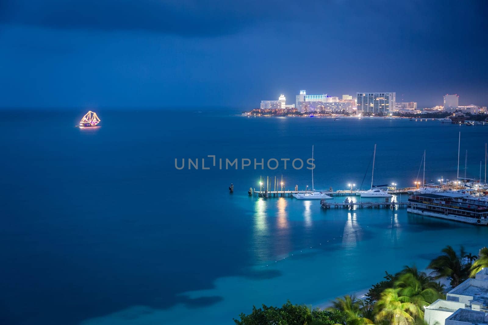 Cancun idyllic caribbean coastline illuminated from above at night, Riviera Maya by positivetravelart