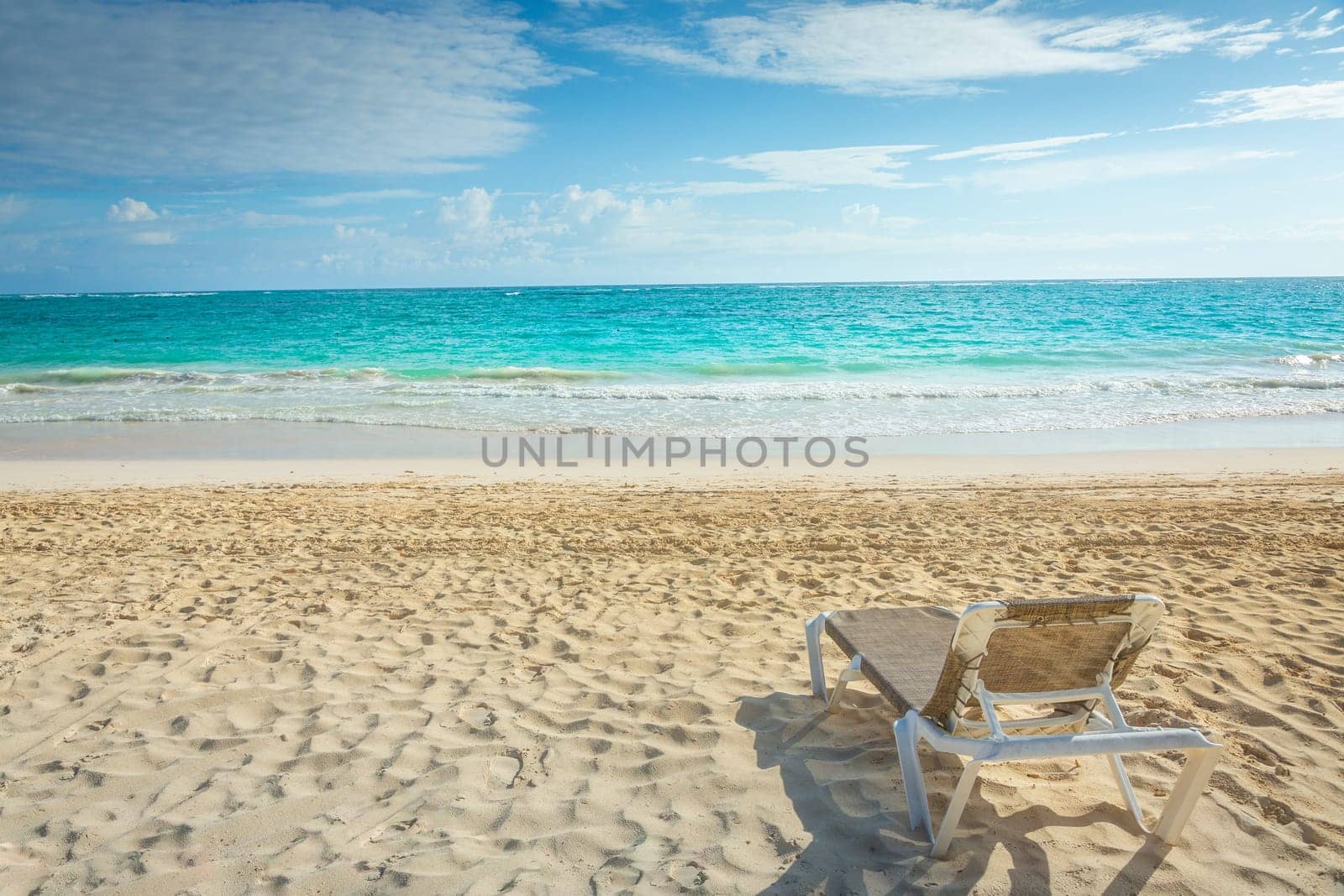 lounge sunbed and secluded eagle beach on Aruba island, Caribbean sea by positivetravelart