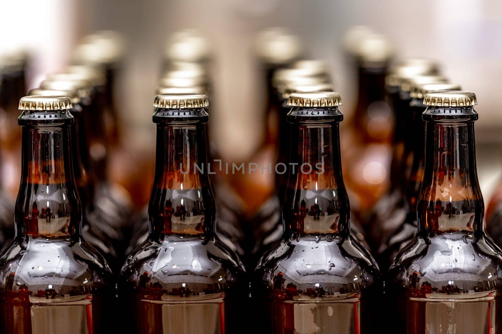 full bottles of beer in a row in the warehouse ready for export. High quality photo