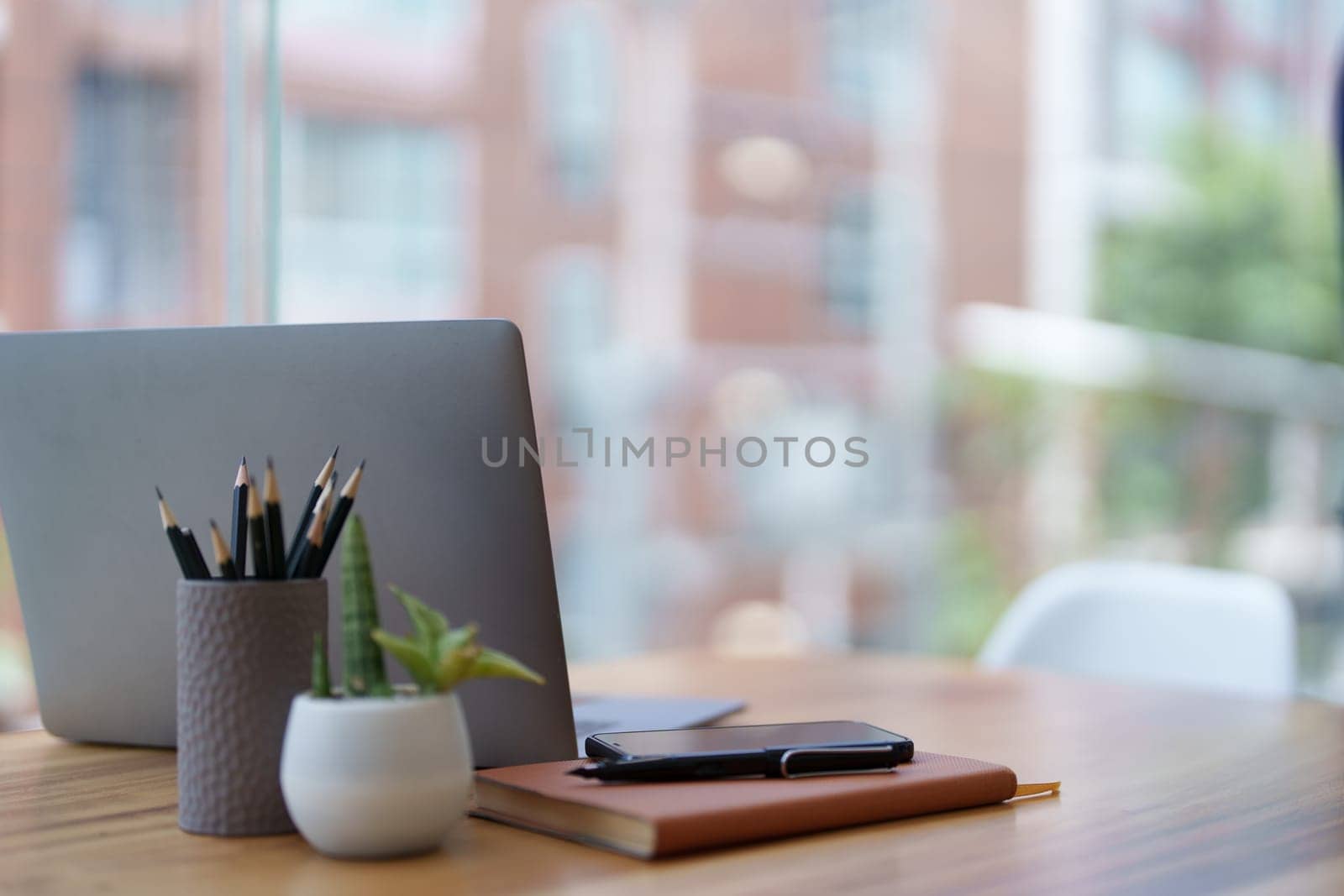 Computers and mobile phones are placed at the desk during lunch breaks by Manastrong