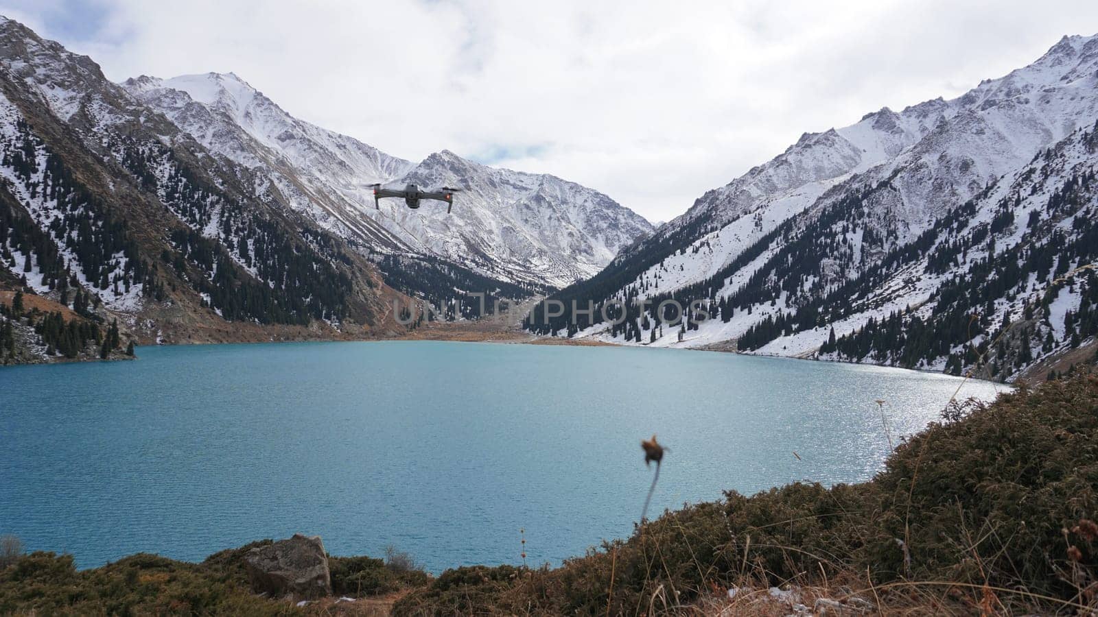 A mountain lake with blue water in winter by Passcal