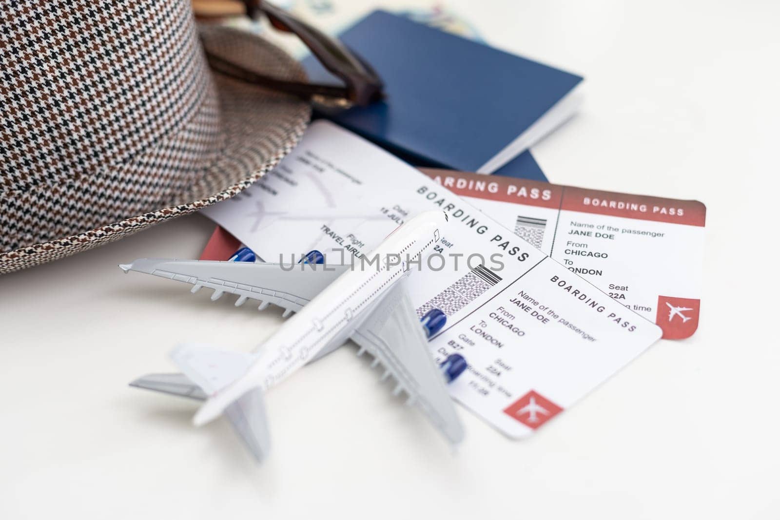 tourist stuff with passport and hat on white background top view