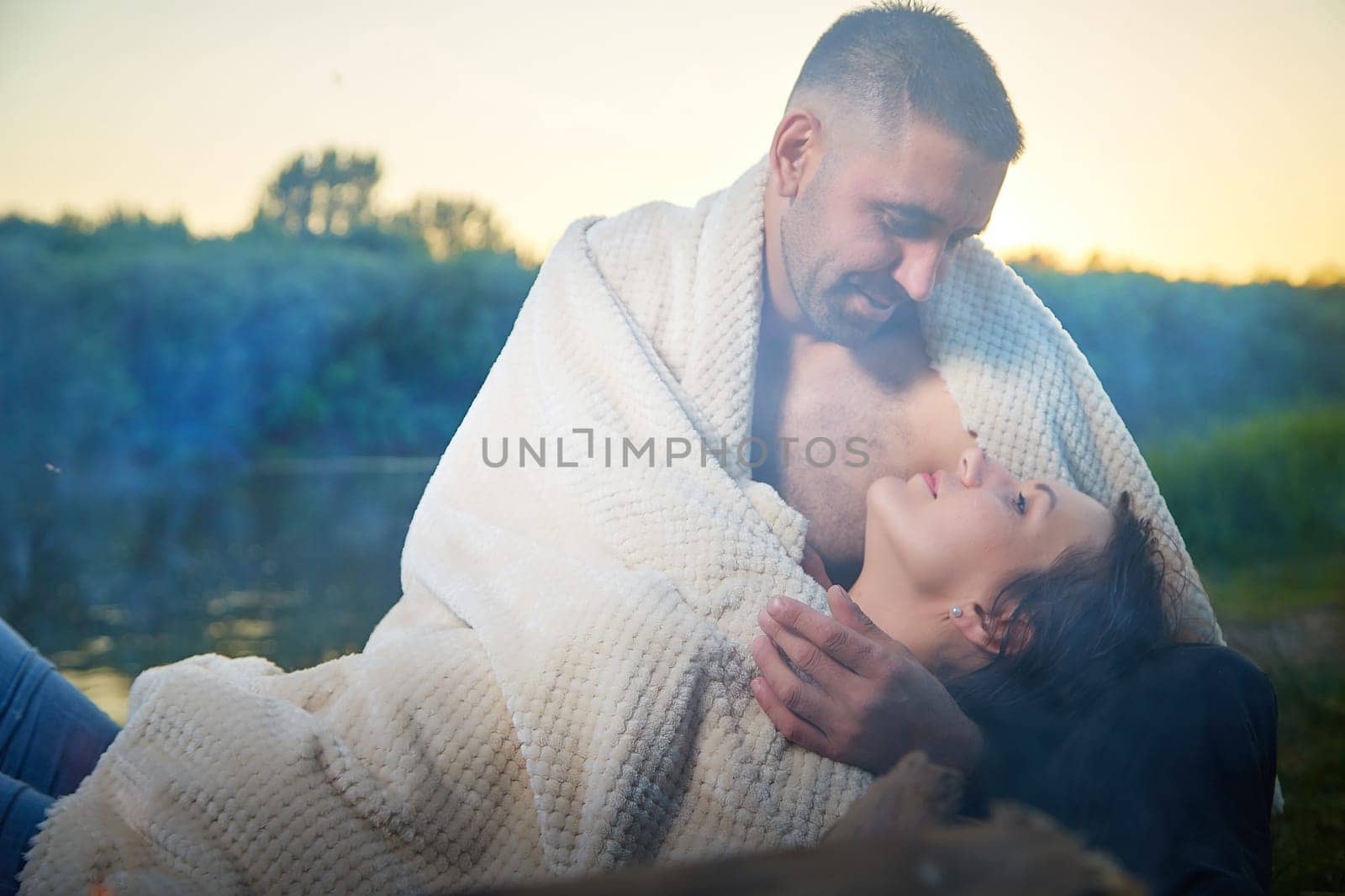 Happy Couple Outdoor relaxin, having fun and hugs on nature in the park in summer day with smog and fog. Family or lovers have date and rest outdoors. Concept of love and friendship by keleny