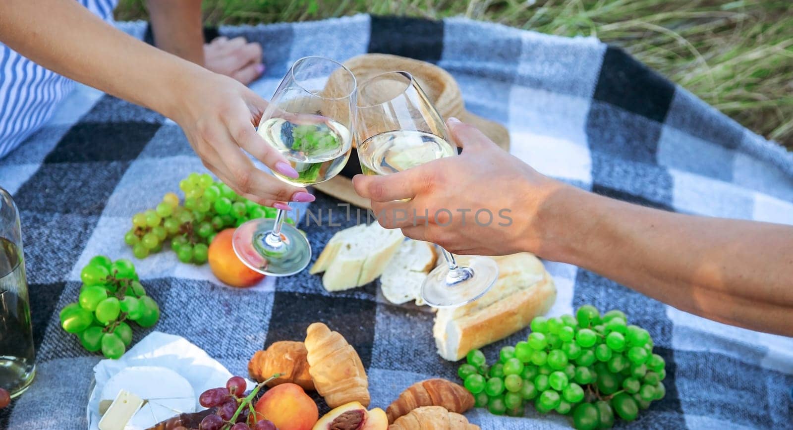 couple in love drinking white wine on a picnic. Selective focus. nature