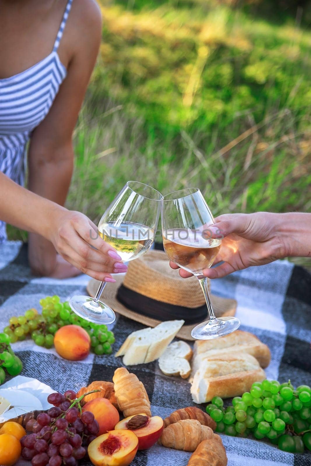 couple in love drinking white wine on a picnic. Selective focus. nature