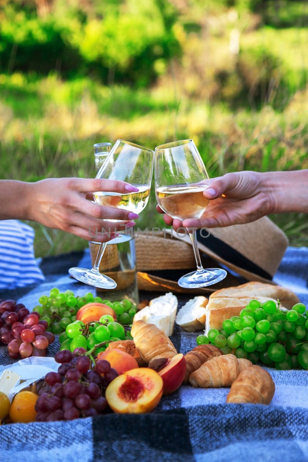 couple in love drinking white wine on a picnic. Selective focus. nature