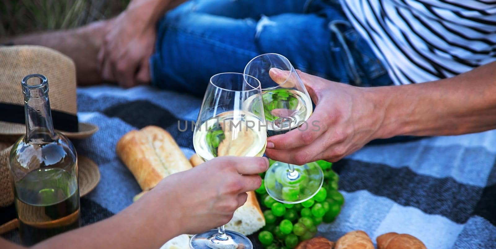 couple in love drinking white wine on a picnic. Selective focus. nature