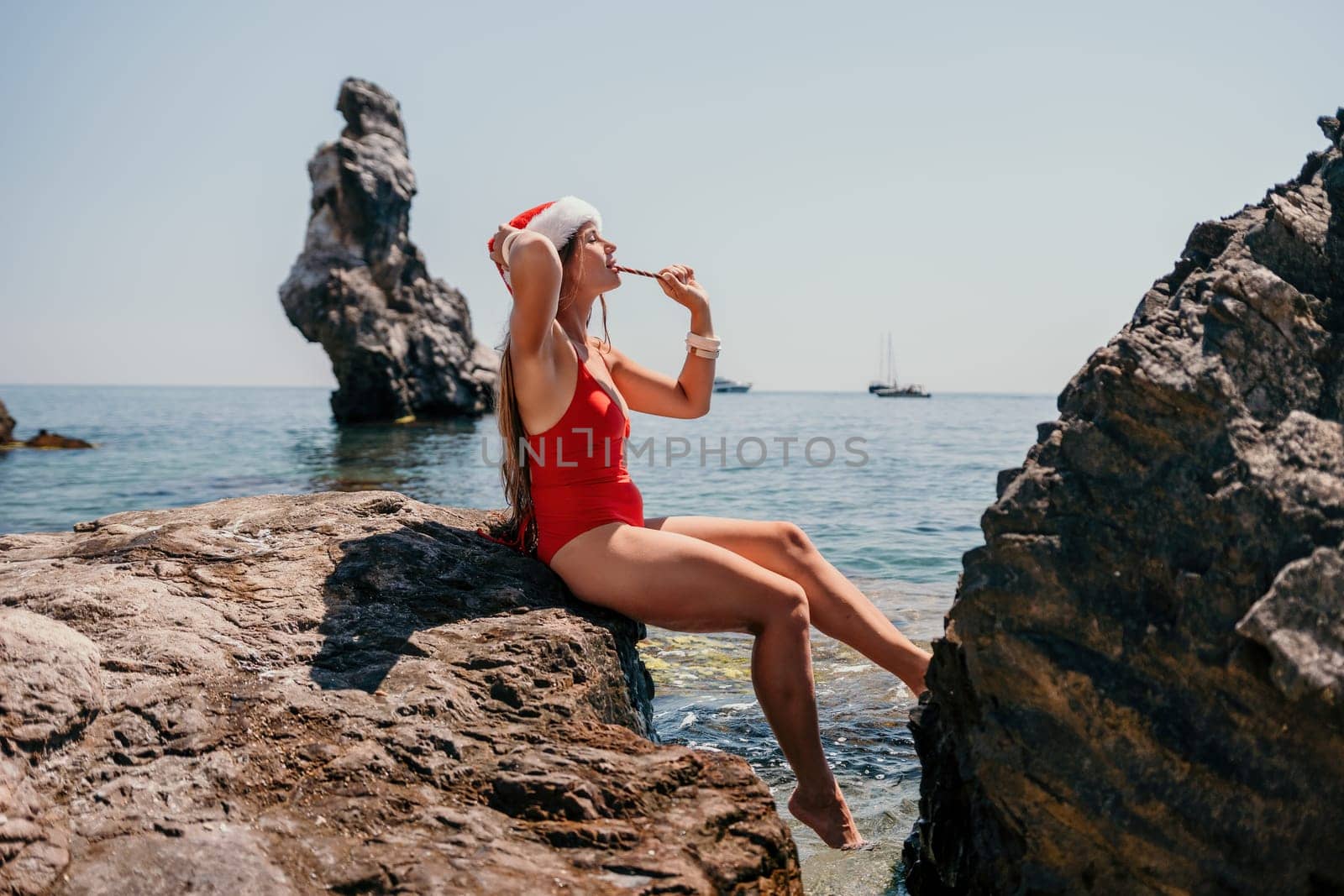 Woman travel sea. Happy tourist taking picture outdoors for memories. Woman traveler looks at the edge of the cliff on the sea bay of mountains, sharing travel adventure journey.