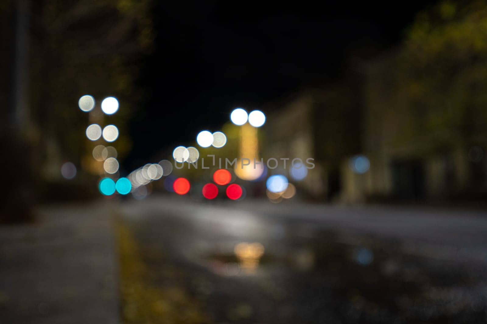 Blurred footage of transport. Blur of city lights along the road, light out of focus at night. Night city traffic, beautiful background