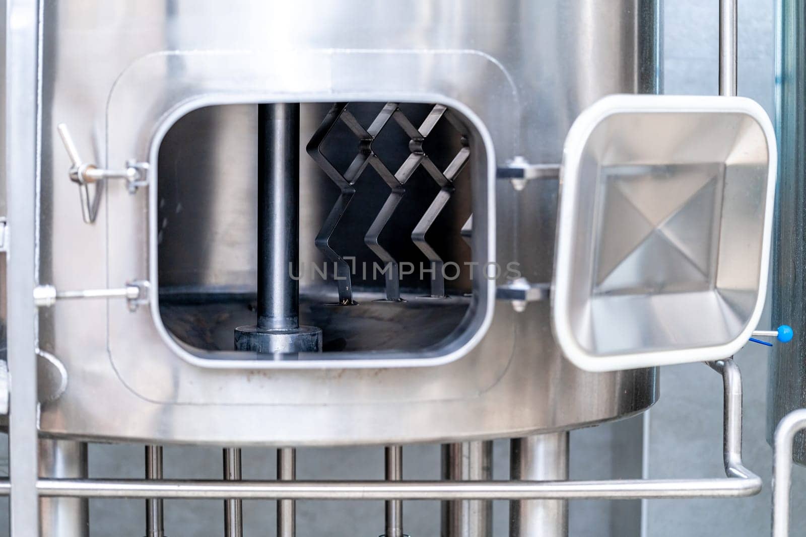 stainless steel boilers and vessels with pipes for brewing beer in a brewery.