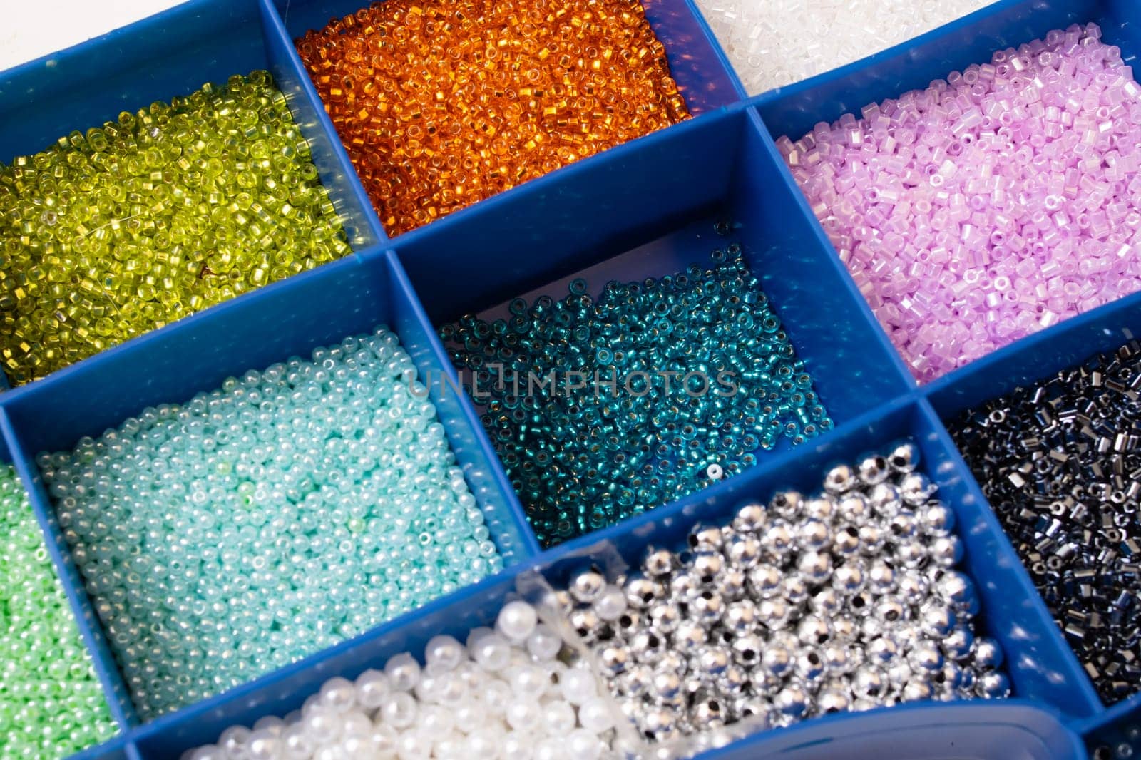 Colorful beads in containers close up, handicrafts, macrophoto