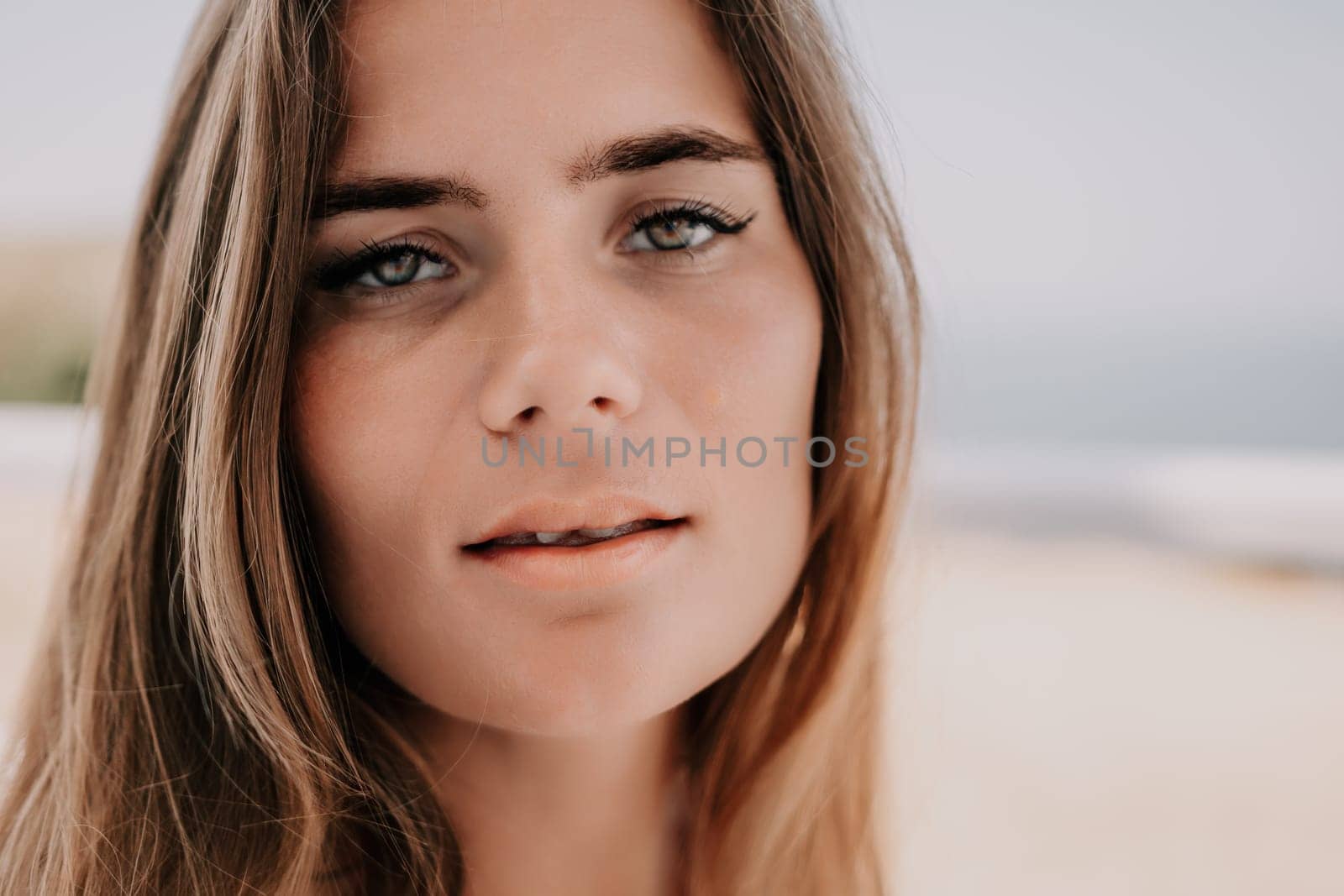 Happy woman portrait in cafe. Boho chic fashion style. Outdoor photo of young happy woman with long hair, sunny weather outdoors sitting in modern cafe. by panophotograph