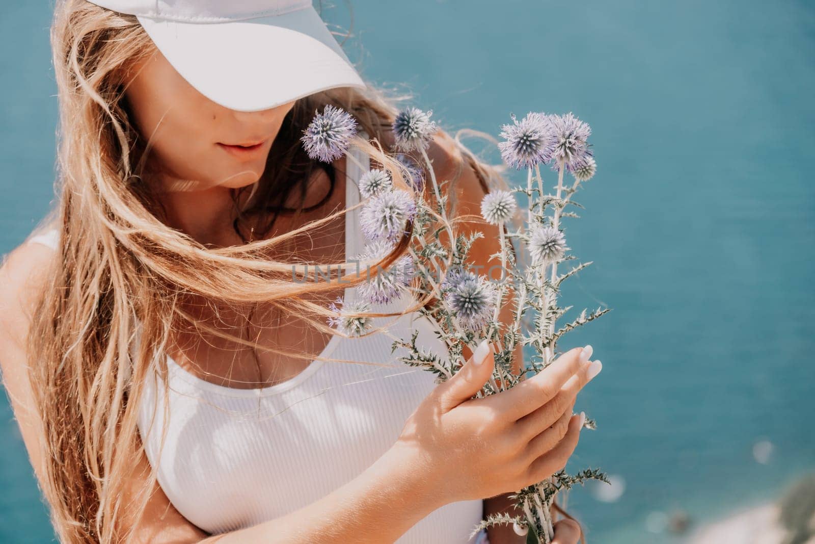 Woman summer travel sea. Happy tourist enjoy taking picture outdoors for memories. Woman traveler posing over sea bay surrounded by volcanic mountains, sharing travel adventure journey by panophotograph