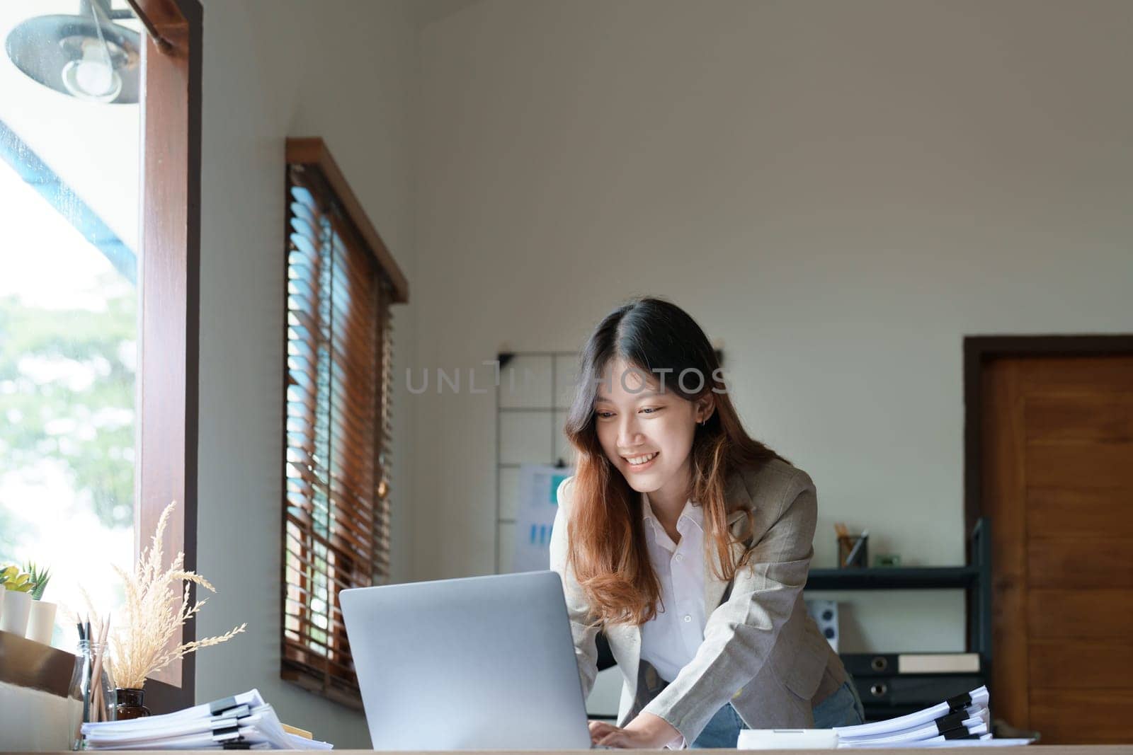 financial, Planning, Marketing and Accounting, portrait of Asian employee checking financial statements using documents and computer laptop at work.