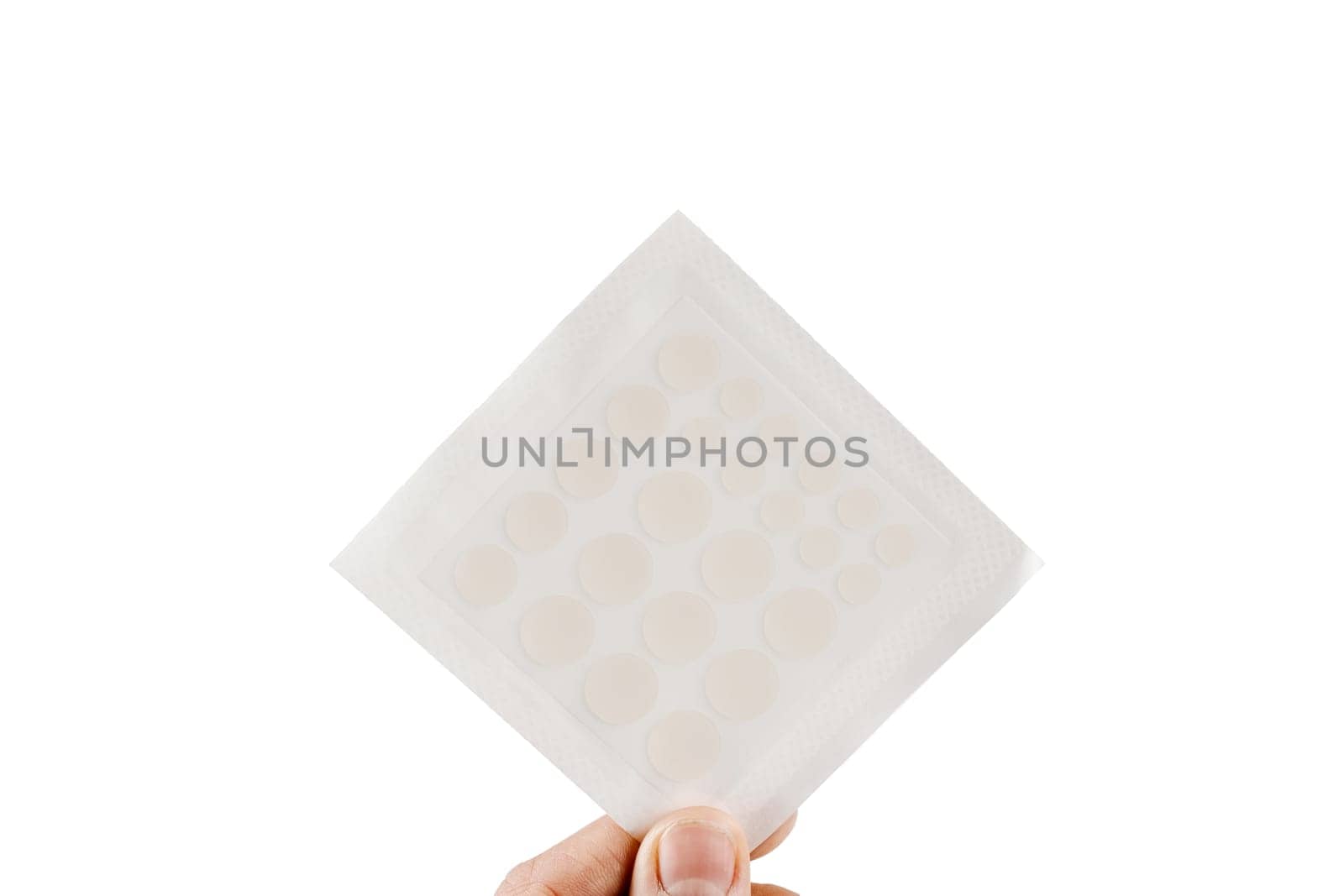 Top view of acne patch for facial rejuvenation. Set of round patches for acne in hand on white background. Facial cleansing cosmetology