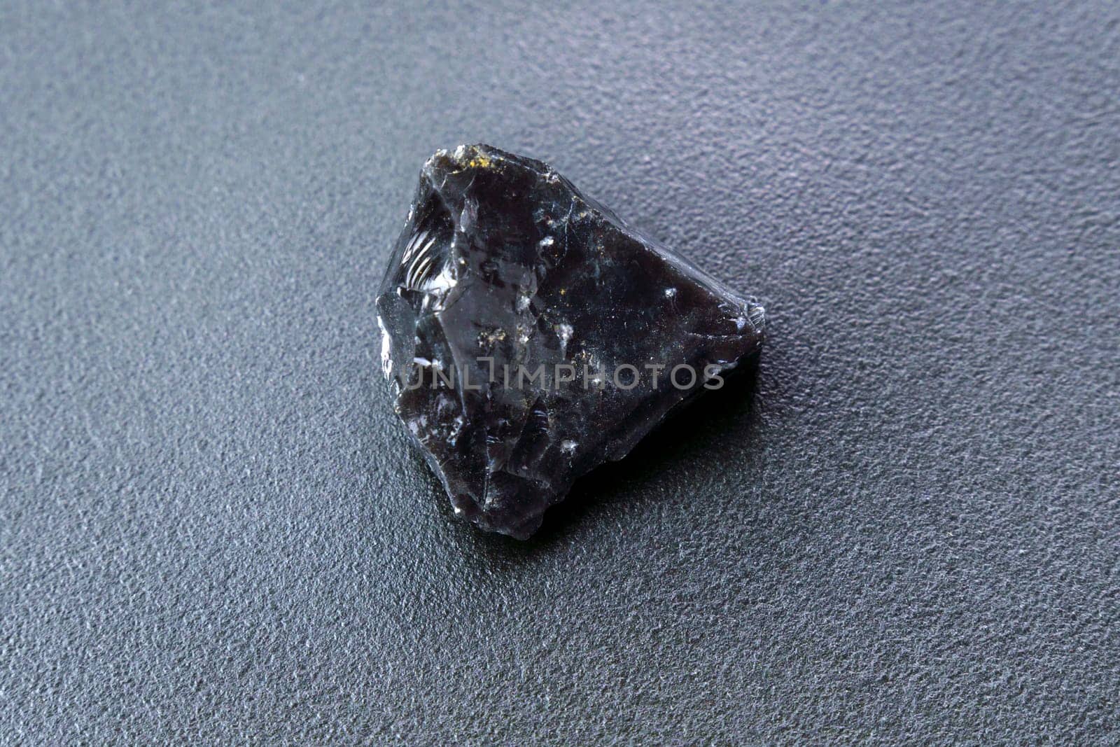 Obsidian rock. Volcanic material. Rough edges. Sharpest rock black background