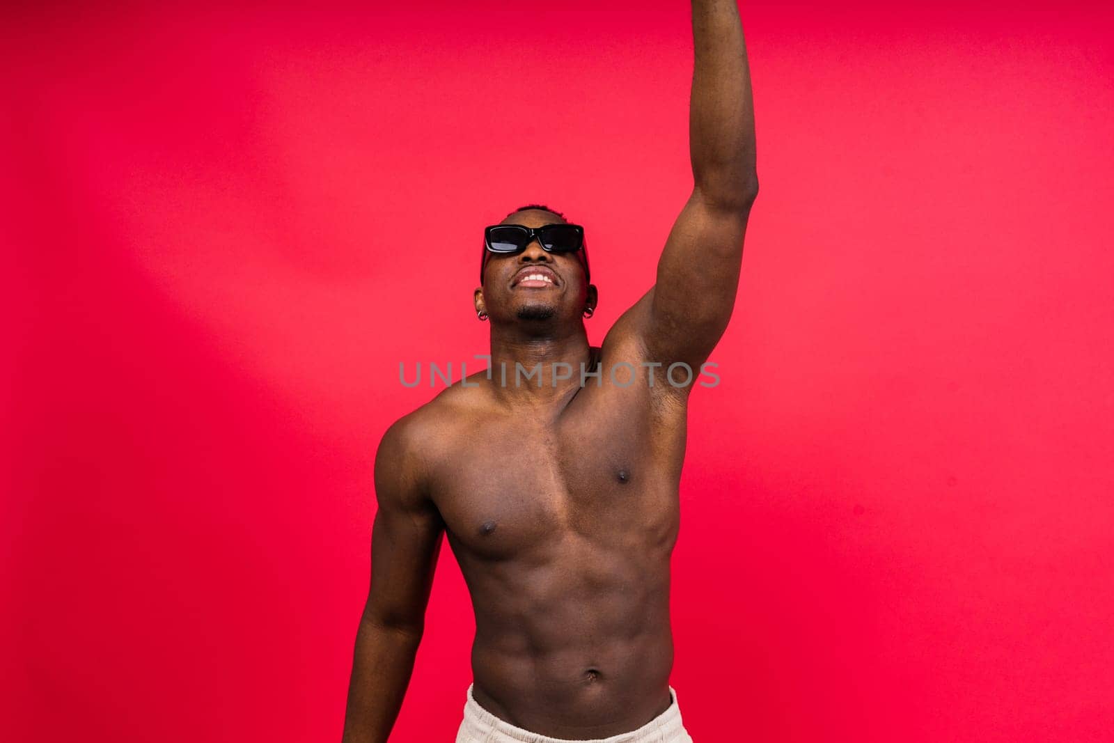 Like what you see. A handsome and muscular young man posing in a studio.