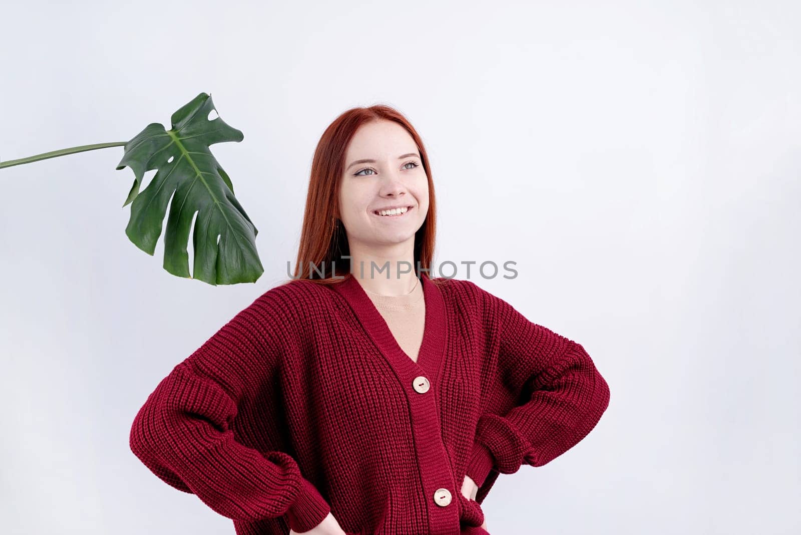 portrait of a happy young beautiful woman in red clothes posing on white background, copy space