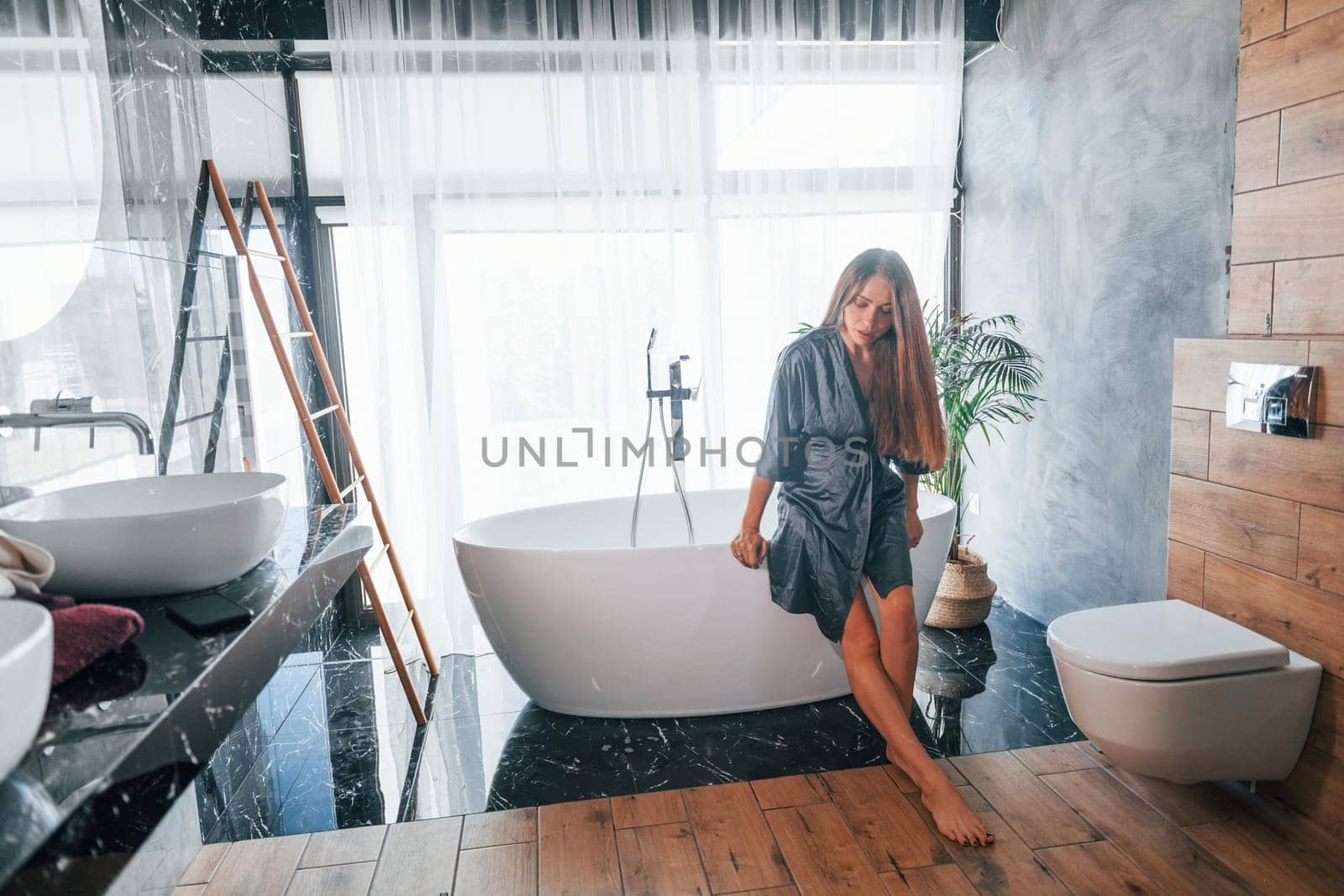 Beautiful young woman have free time at home in the bath.