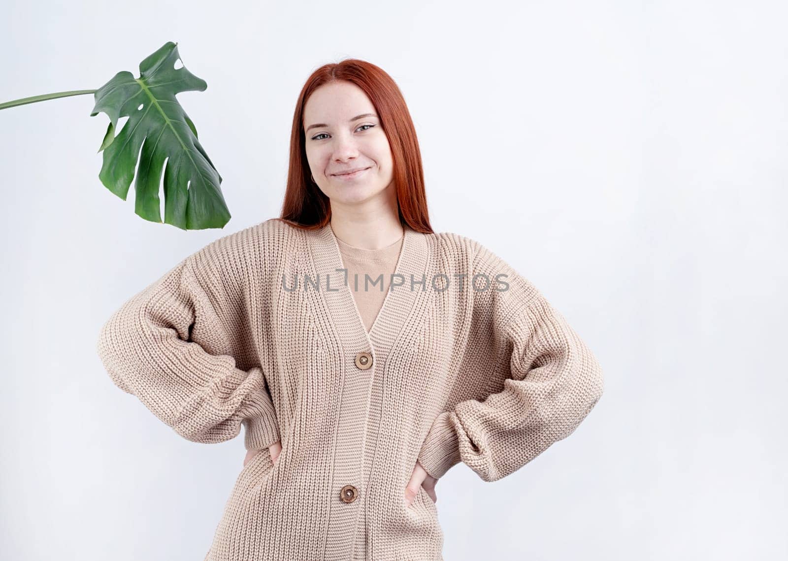 portrait of a young beautiful woman in beigeclothes posing on white background, copy space by Desperada